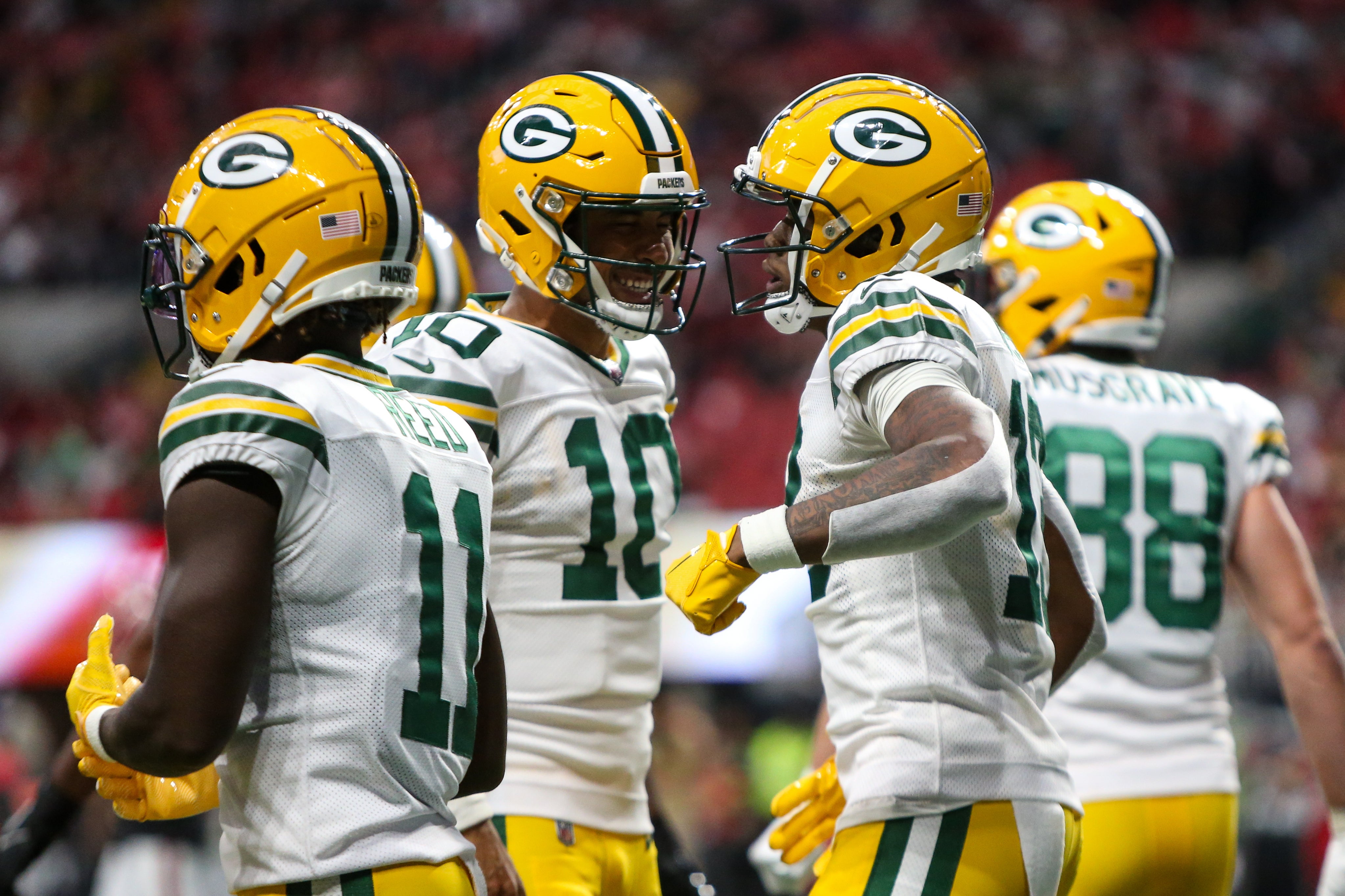 Sep 17, 2023; Atlanta, Georgia, USA; Green Bay Packers quarterback Jordan Love (10) and wide receiver Dontayvion Wicks (13) celebrate after a touchdown against the Atlanta Falcons in the second half at Mercedes-Benz Stadium. Mandatory Credit: Brett Davis-USA TODAY Sports