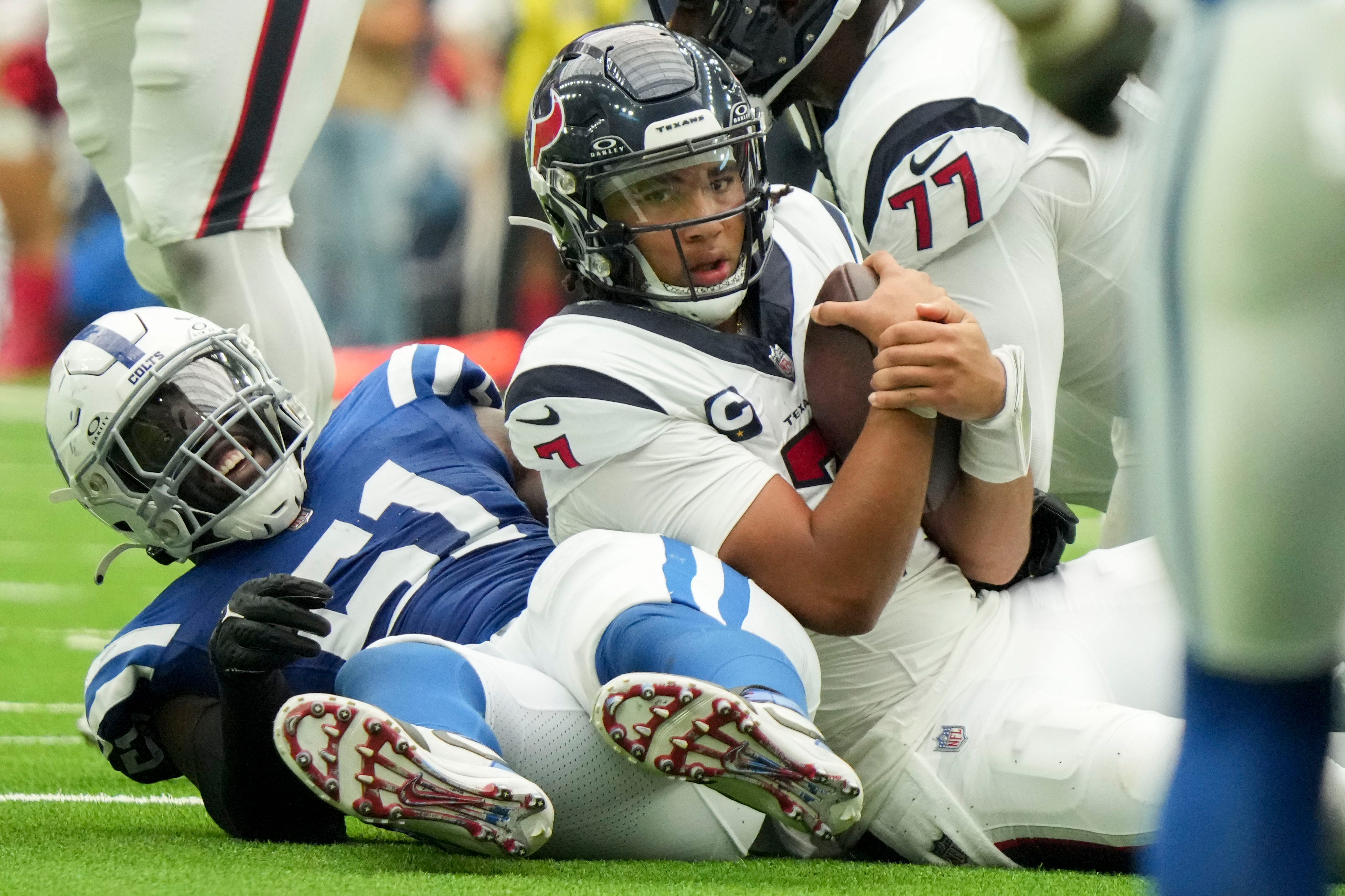 Indianapolis Colts defensive end Kwity Paye (51) smiles after bringing down Houston Texans quarterback C.J. Stroud (7) on Sunday, Sept. 17, 2023, during a game against the Houston Texans at NRG Stadium in Houston