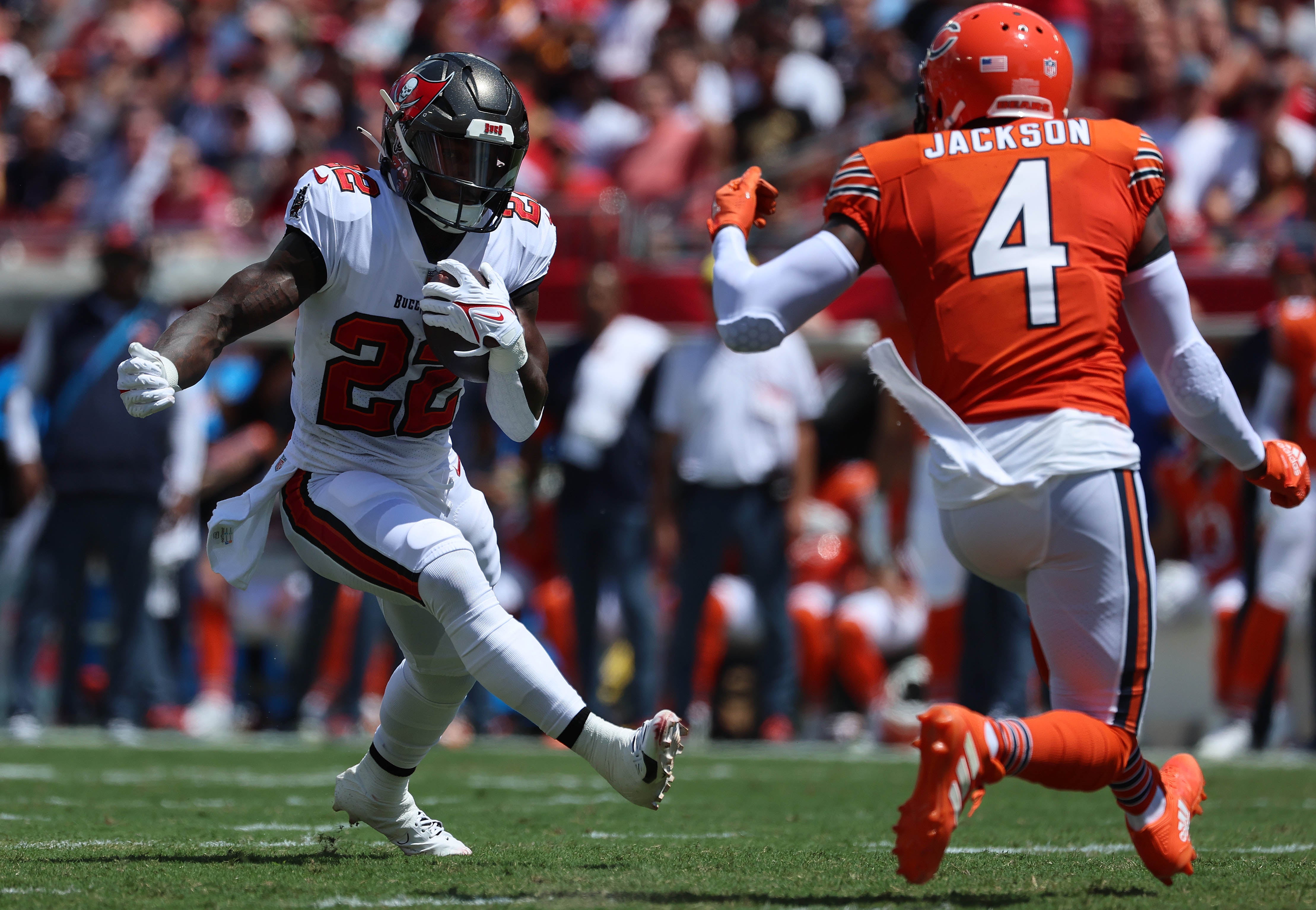Sep 17, 2023; Tampa, Florida, USA; Tampa Bay Buccaneers running back Chase Edmonds (22) runs with the ball as Chicago Bears safety Eddie Jackson (4) defends during the first quarter at Raymond James Stadium. Mandatory Credit: Kim Klement Neitzel-USA TODAY Sports  