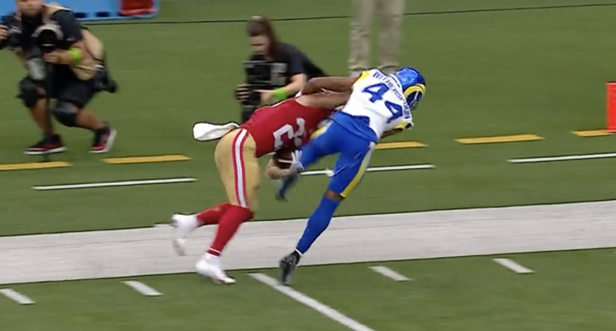 Christian McCaffrey stiff arms Ahkello Witherspoon at the end of a 51-yard run for the 49ers against the Rams. Credit: David Lombardi on X (formerly Twitter).