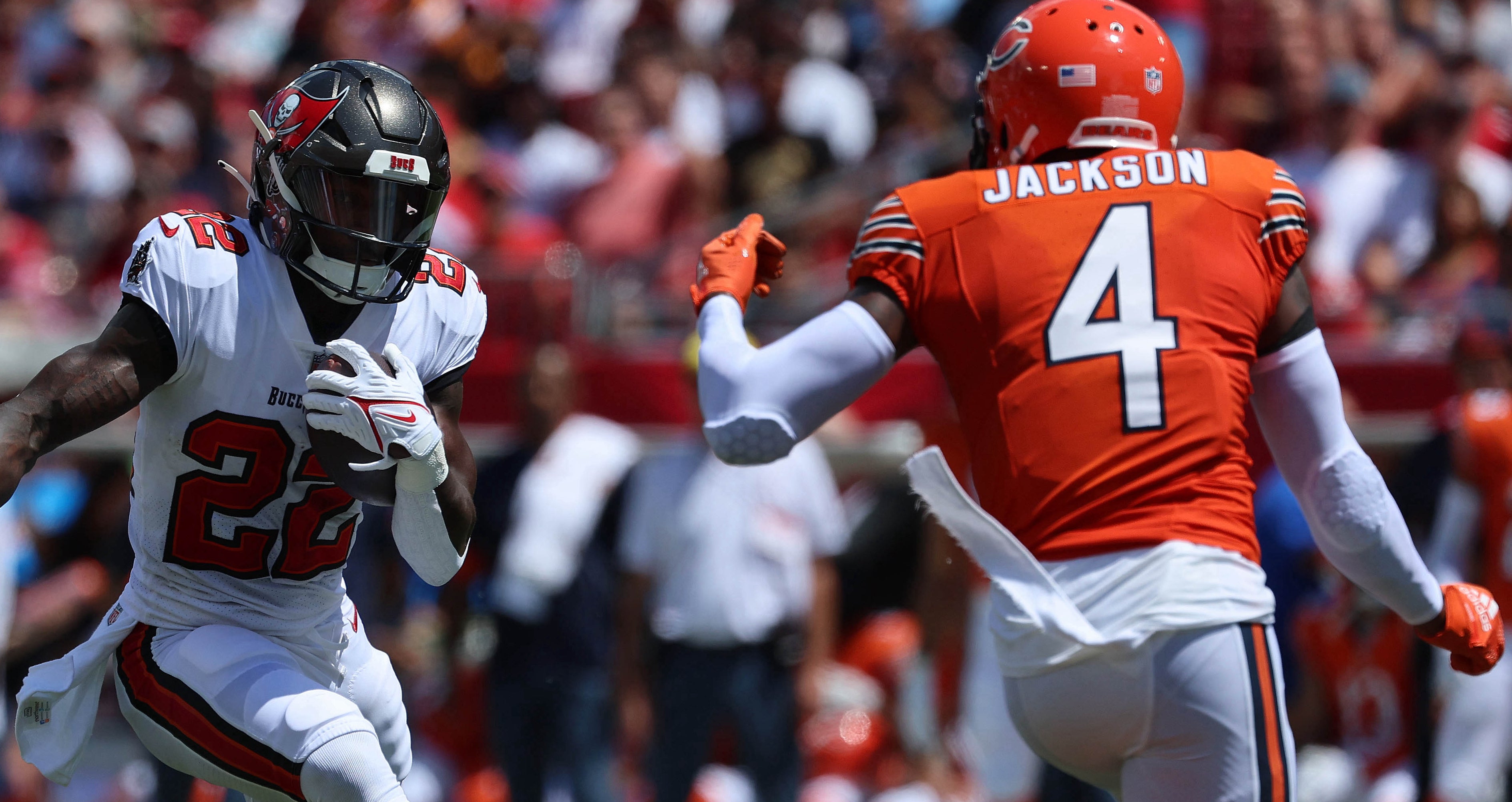 Sep 17, 2023; Tampa, Florida, USA; Tampa Bay Buccaneers running back Chase Edmonds (22) runs with the ball as Chicago Bears safety Eddie Jackson (4) defends during the first quarter at Raymond James Stadium. Mandatory Credit: Kim Klement Neitzel-USA TODAY Sports