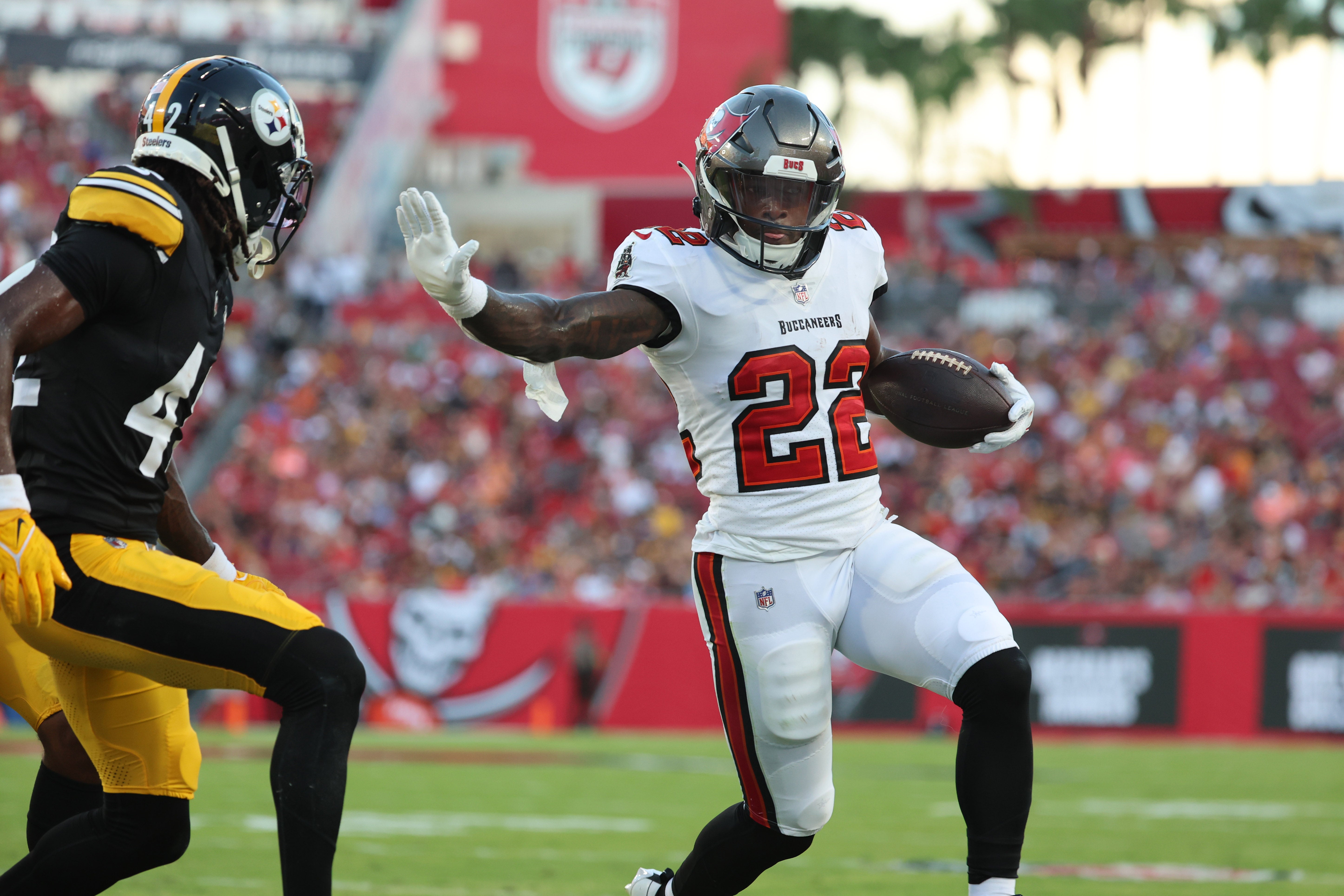 Aug 11, 2023; Tampa, Florida, USA; Tampa Bay Buccaneers running back Chase Edmonds (22) runs with the ball as Pittsburgh Steelers cornerback James Pierre (42) defends during the first half at Raymond James Stadium. Mandatory Credit: Kim Klement Neitzel-USA TODAY Sports