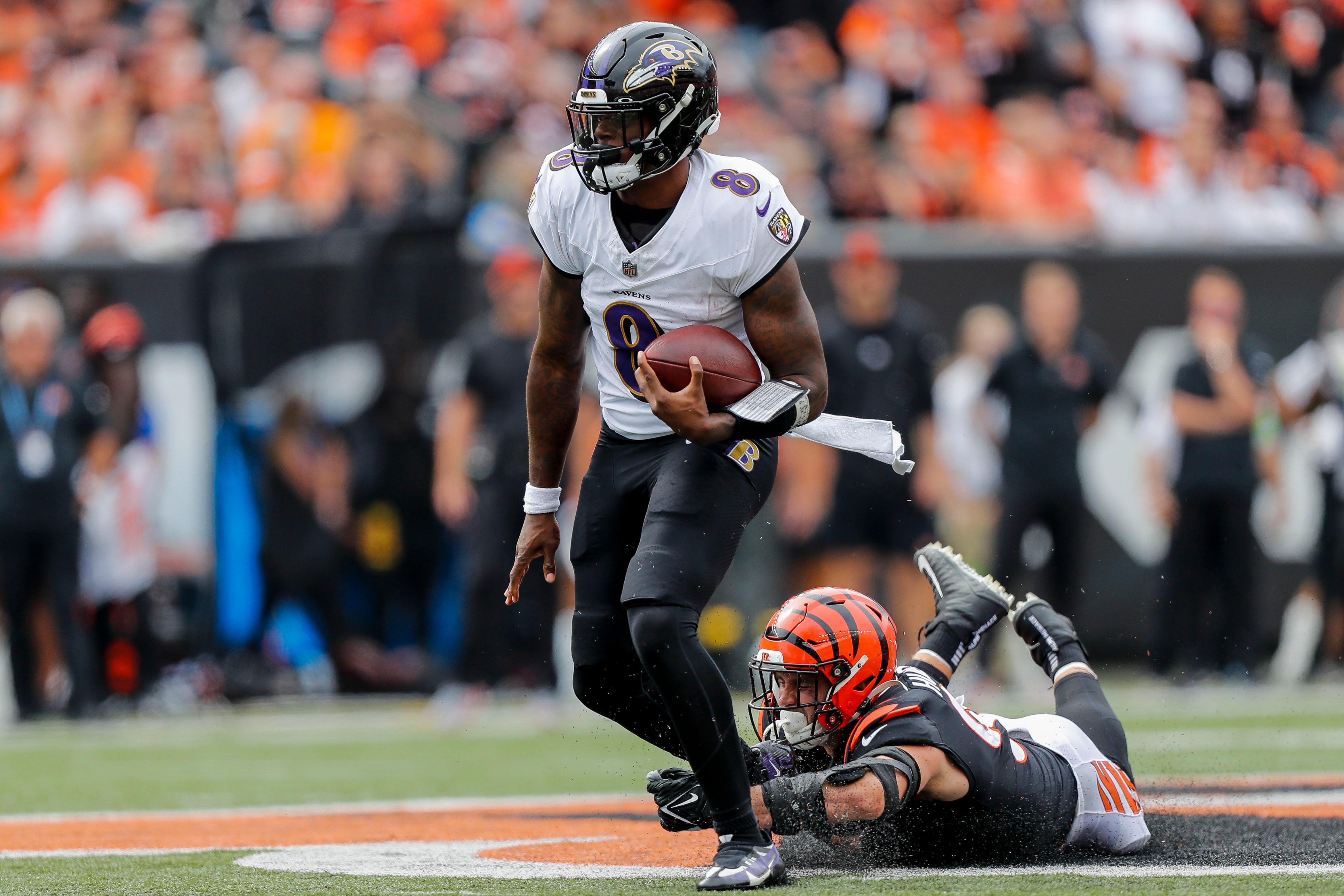 Sep 17, 2023; Cincinnati, Ohio, USA; Baltimore Ravens quarterback Lamar Jackson (8) runs with the ball against Cincinnati Bengals defensive end Sam Hubbard (94) in the second half at Paycor Stadium. Mandatory Credit: Katie Stratman-USA TODAY Sports
