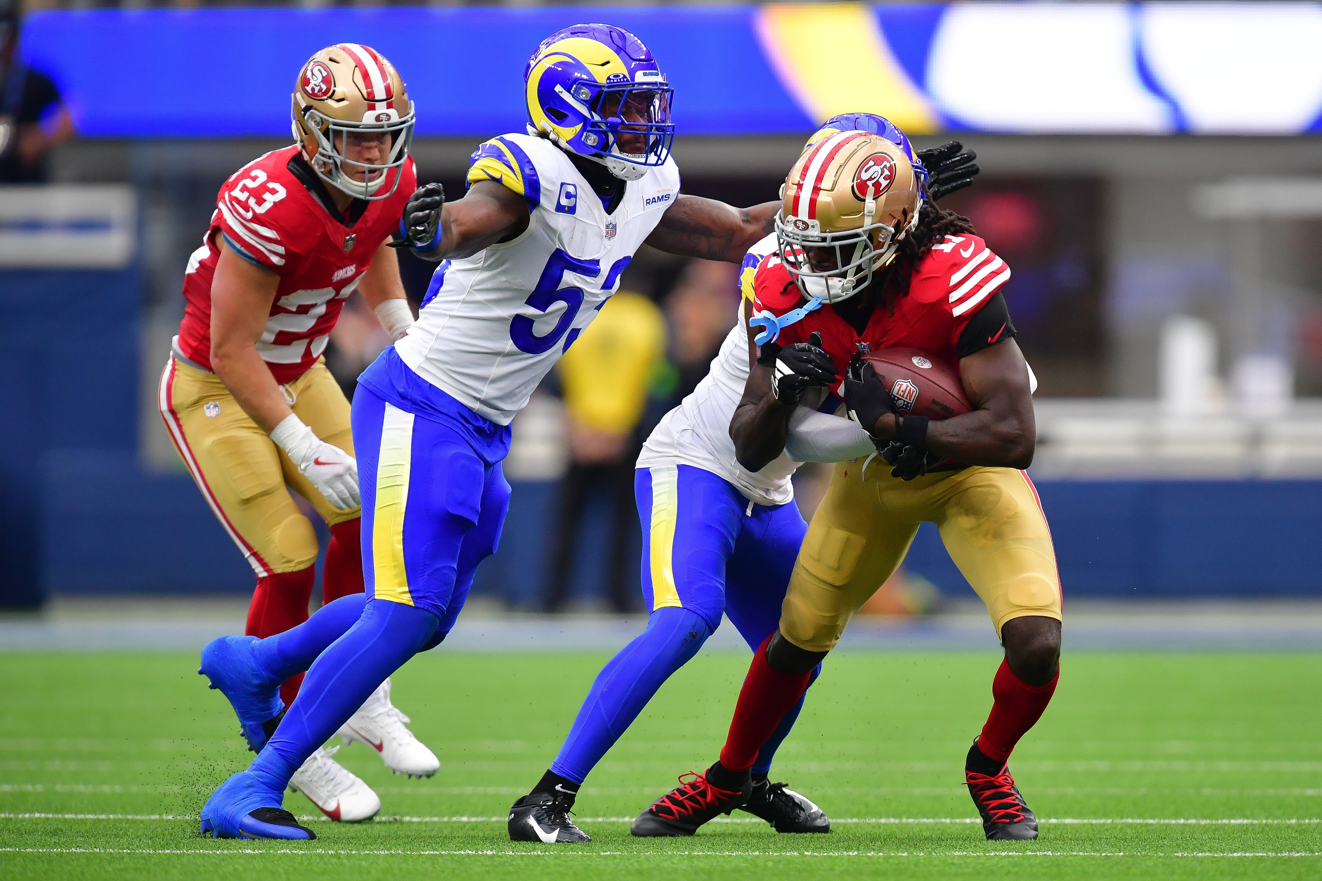 Sep 17, 2023; Inglewood, California, USA; San Francisco 49ers wide receiver Brandon Aiyuk (11) runs the ball against Los Angeles Rams linebacker Ernest Jones (53) during the first half at SoFi Stadium. Mandatory Credit: Gary A. Vasquez-USA TODAY Sports