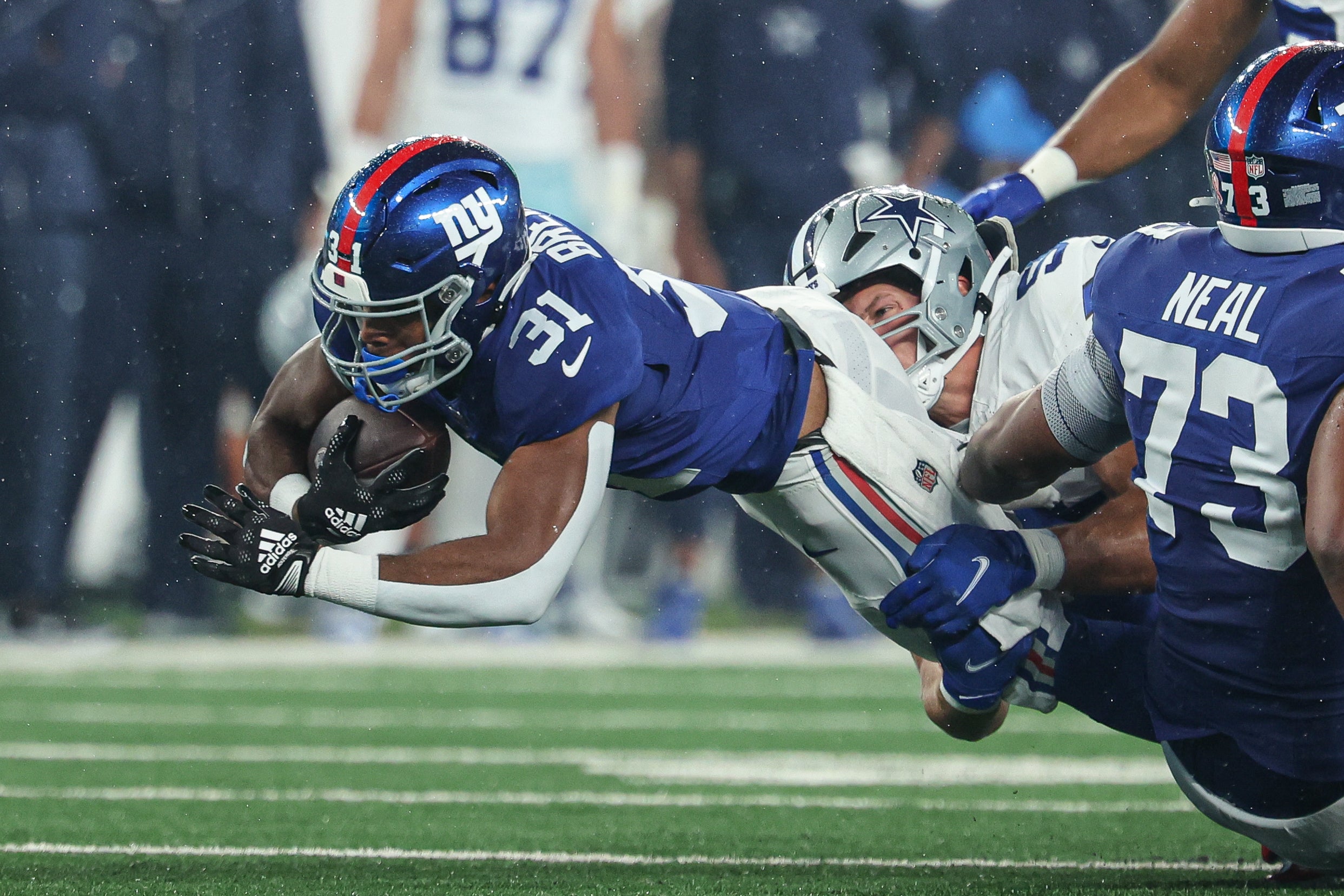 Sep 10, 2023; East Rutherford, New Jersey, USA; New York Giants running back Matt Breida (31) fights for yards as Dallas Cowboys linebacker Leighton Vander Esch (55) tackles during the first quarter at MetLife Stadium. Mandatory Credit: Vincent Carchietta-USA TODAY Sports