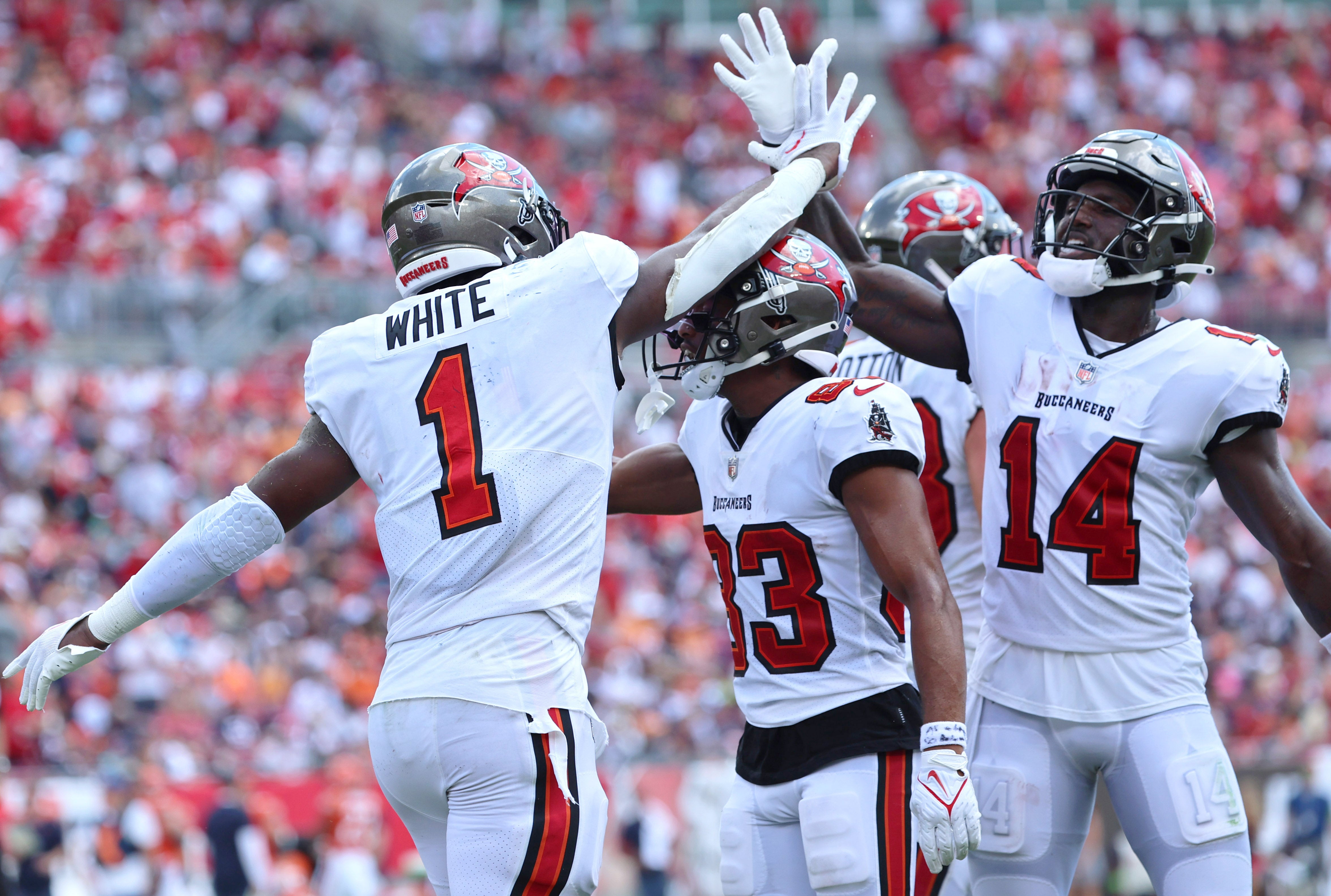 Sep 17, 2023; Tampa, Florida, USA; Tampa Bay Buccaneers running back Rachaad White (1) celebrates with wide receivers Deven Thompkins (83) and Chris Godwin (14) after scoring a touchdown against the Chicago Bears during the second quarter at Raymond James Stadium. Kim Klement Neitzel-USA TODAY Sports