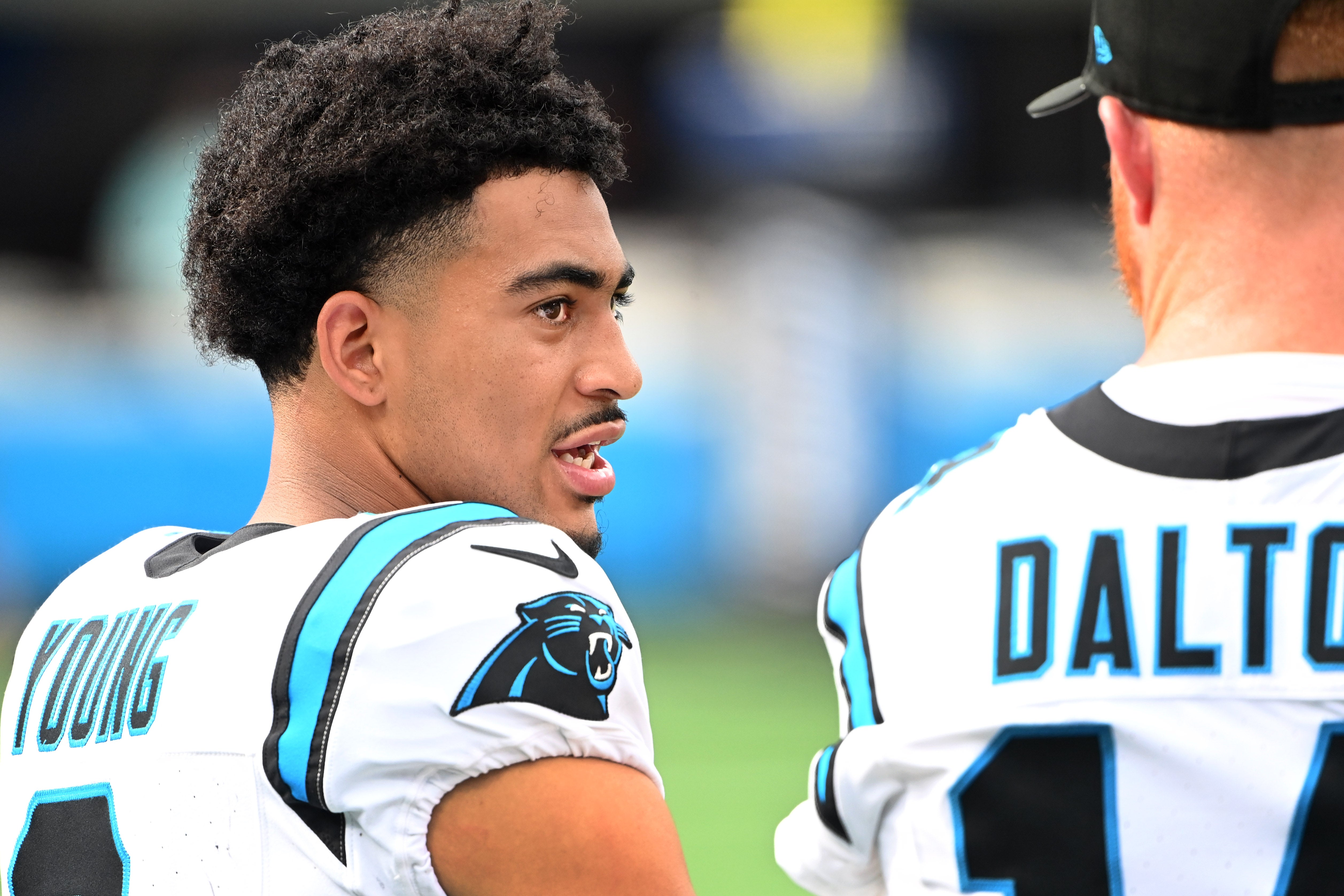 Aug 12, 2023; Charlotte, North Carolina, USA; Carolina Panthers quarterback Bryce Young (9) talks with quarterback Andy Dalton (14) in the second quarter at Bank of America Stadium. Mandatory Credit: Bob Donnan-USA TODAY Sports.