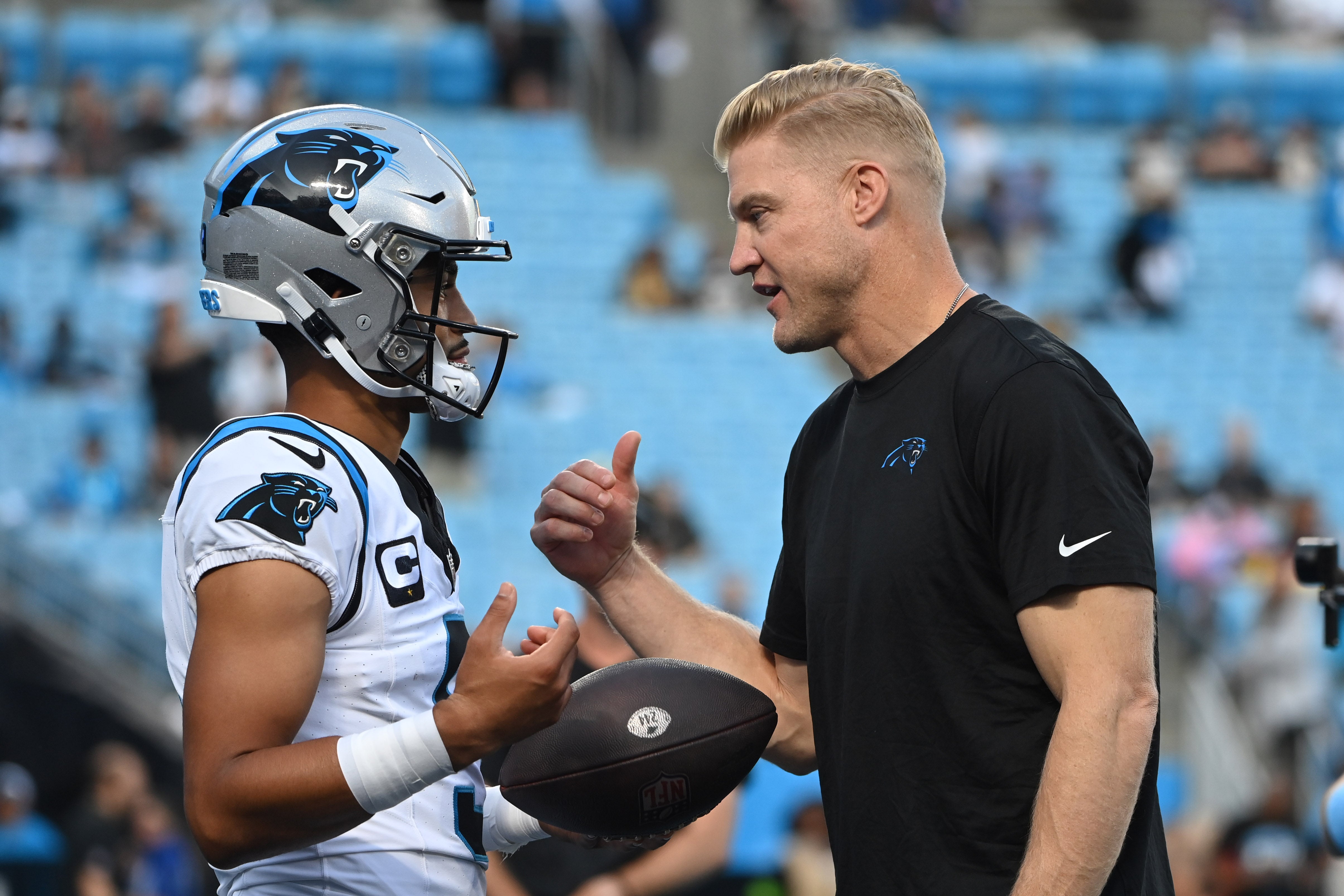 Sep 18, 2023; Charlotte, North Carolina, USA; Carolina Panthers quarterback Bryce Young (9) with quarterbacks coach Josh McCowen before the game at Bank of America Stadium. Mandatory Credit: Bob Donnan-USA TODAY Sports.