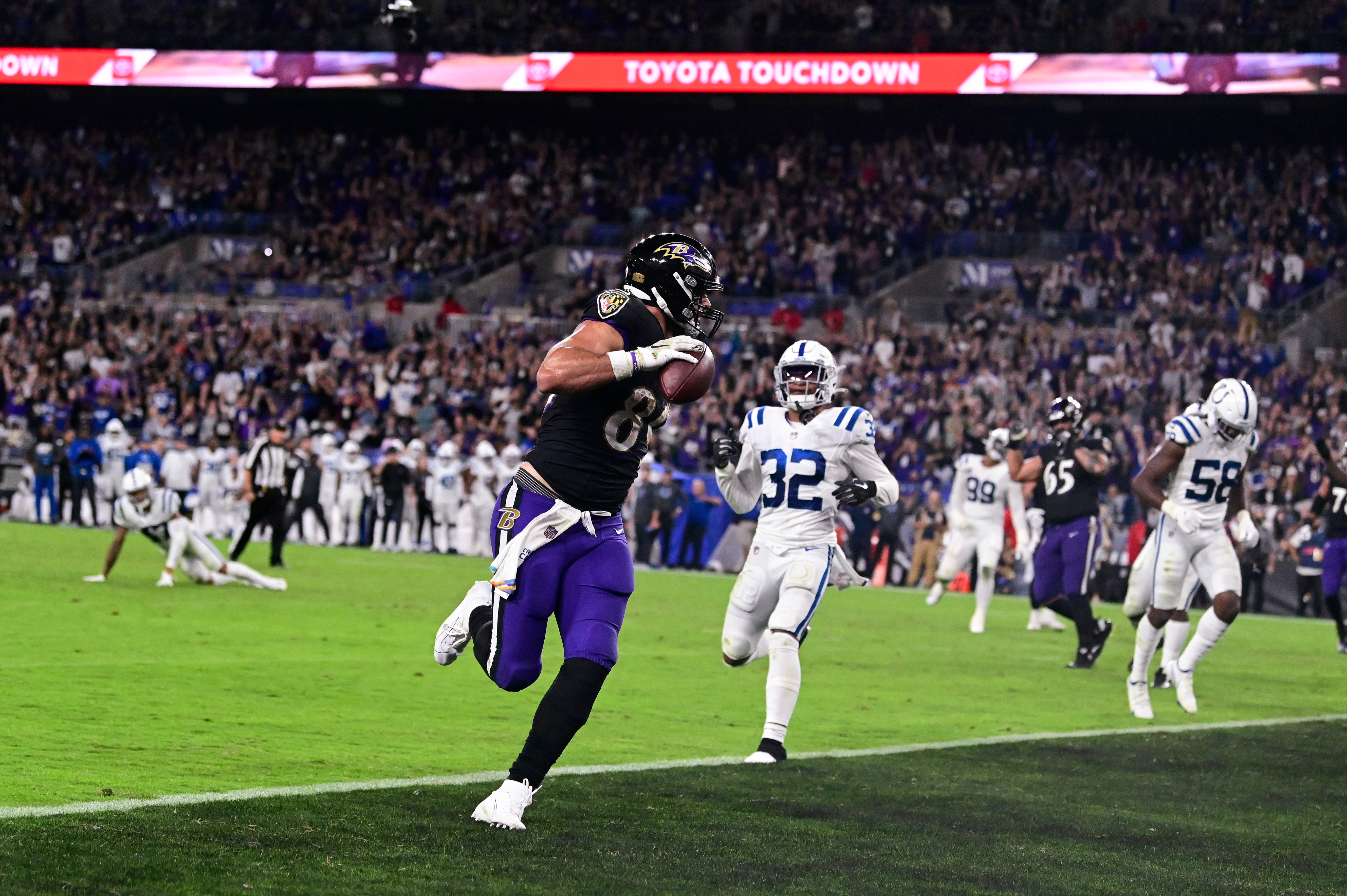 Oct 11, 2021; Baltimore, Maryland, USA; Baltimore Ravens tight end Mark Andrews (89) scores a second half touchdown as Indianapolis Colts free safety Julian Blackmon (32) looks on at M&T Bank Stadium. Mandatory Credit: Tommy Gilligan-USA TODAY Sports