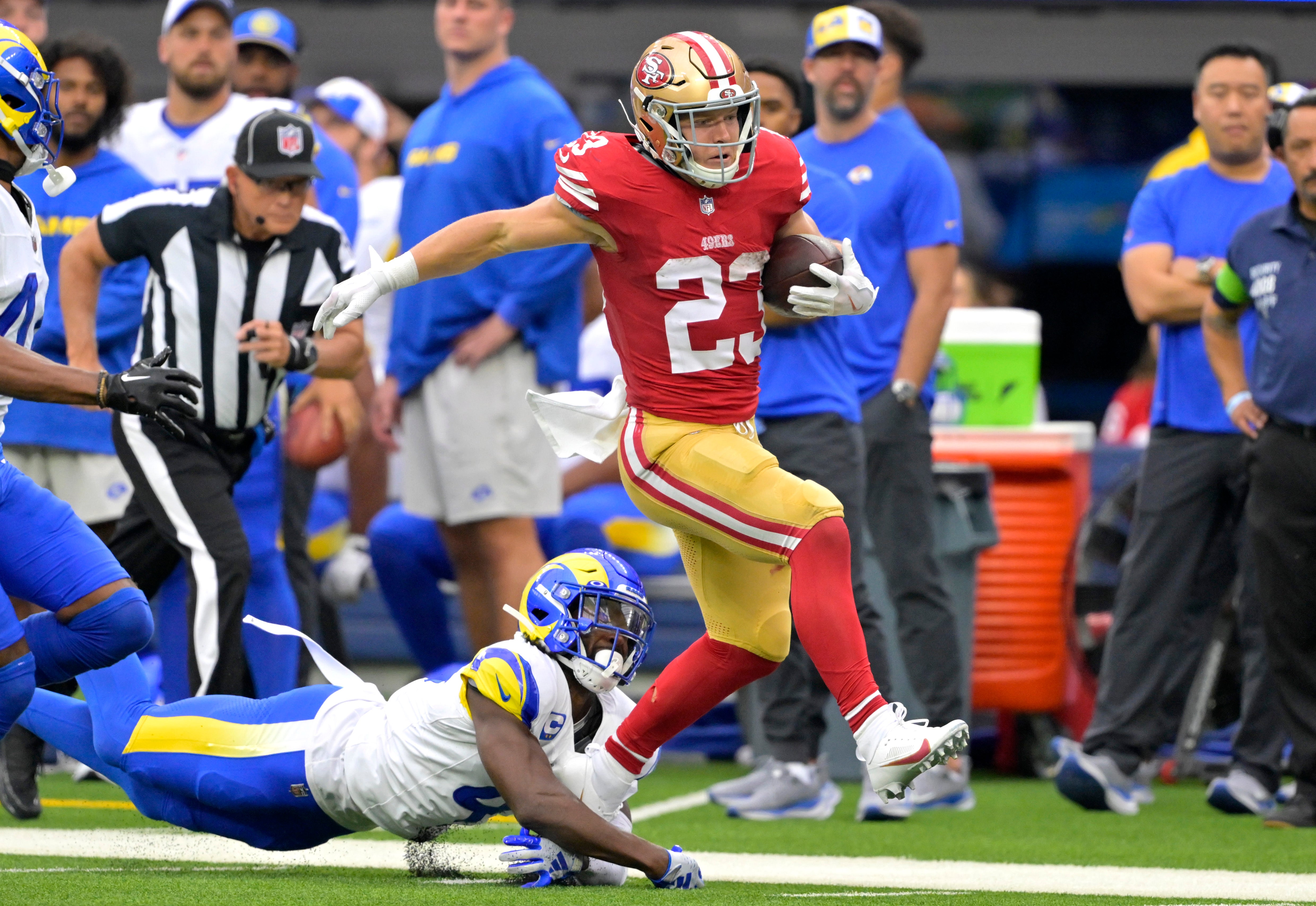 Sep 17, 2023; Inglewood, California, USA; San Francisco 49ers running back Christian McCaffrey (23) takes the ball down the sideline past Los Angeles Rams safety Jordan Fuller (4) for a first down at SoFi Stadium. Mandatory Credit: Jayne Kamin-Oncea-USA TODAY Sports