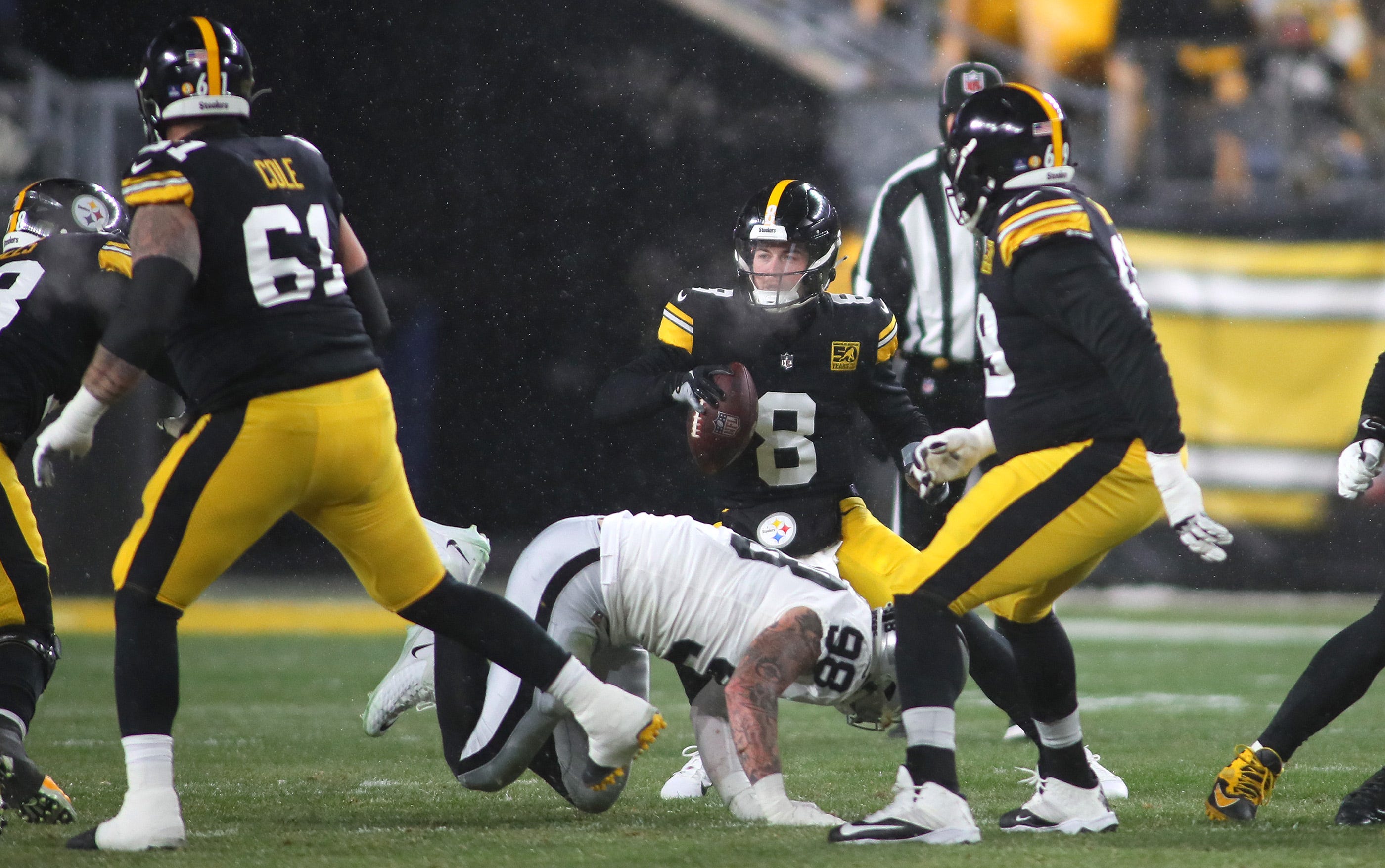 Pittsburgh Steelers Kenny Pickett (8) avoids being sacked by Las Vegas Raiders Maxx Crosby (98) during the first half at Acrisure Stadium in Pittsburgh, PA on December 24, 2022. Pittsburgh Steelers Vs Las Vegas Raiders Week 16