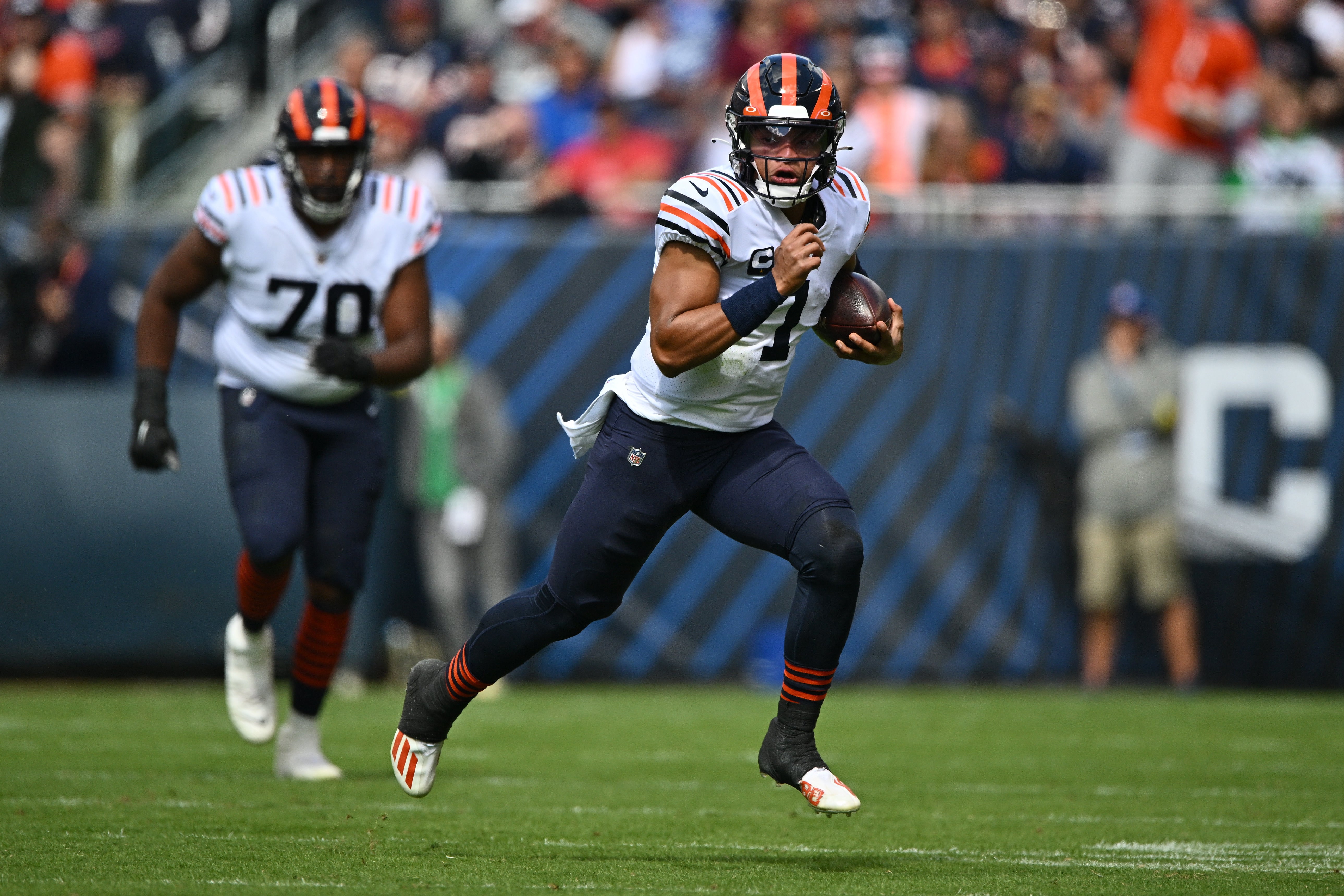 Sep 25, 2022; Chicago, Illinois, USA; Chicago Bears quarterback Justin Fields (1) scrambles for a 29-yard pick up in the first quarter against the Houston Texans at Soldier Field. Mandatory Credit: Jamie Sabau-USA TODAY Sports
