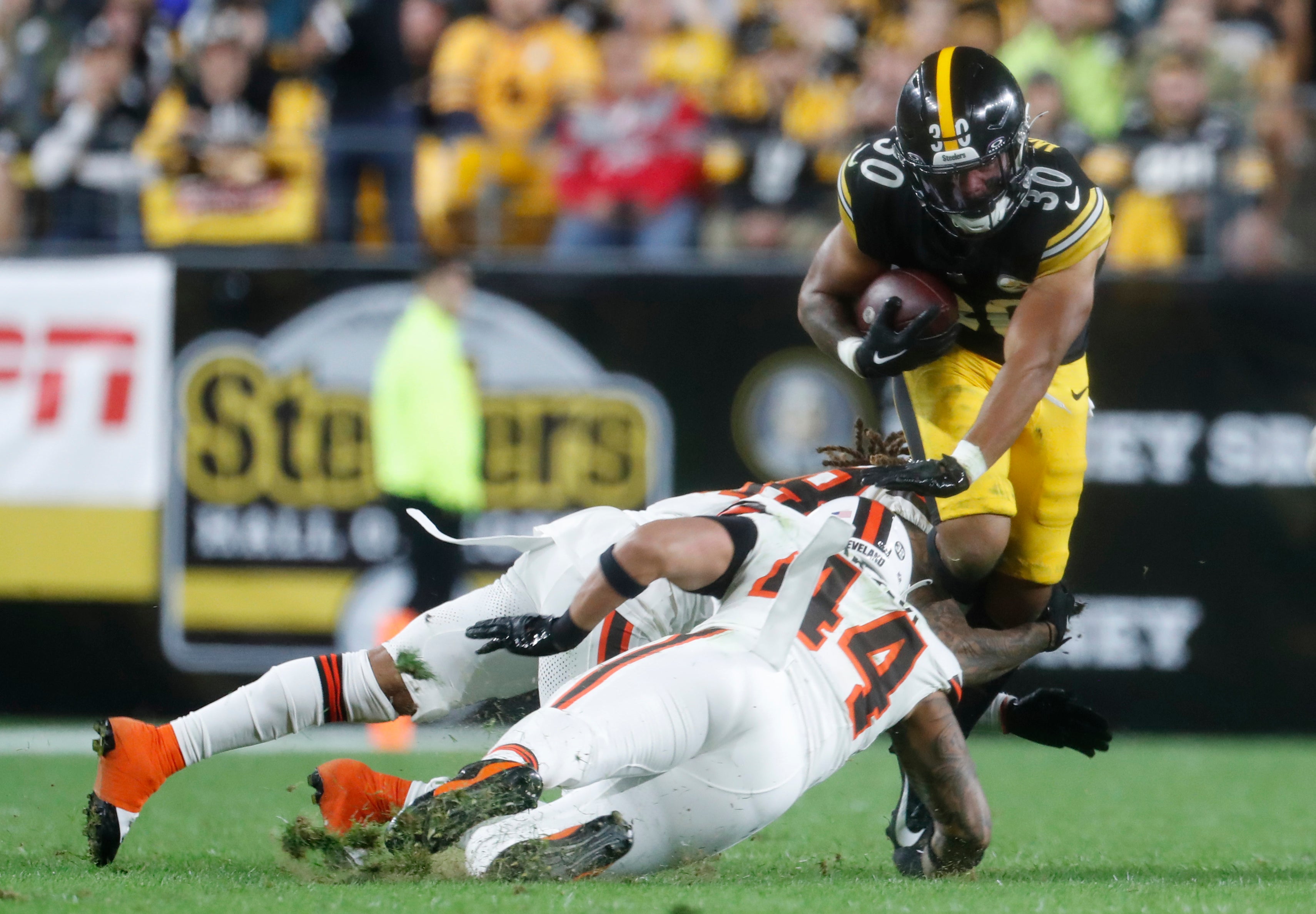 Sep 18, 2023; Pittsburgh, Pennsylvania, USA; Pittsburgh Steelers running back Jaylen Warren (30) runs the ball against Cleveland Browns cornerback Mike Ford (rear) and linebacker Sione Takitaki (44) during the third quarter at Acrisure Stadium. Pittsburgh won 26-22. Mandatory Credit: Charles LeClaire-USA TODAY Sports  