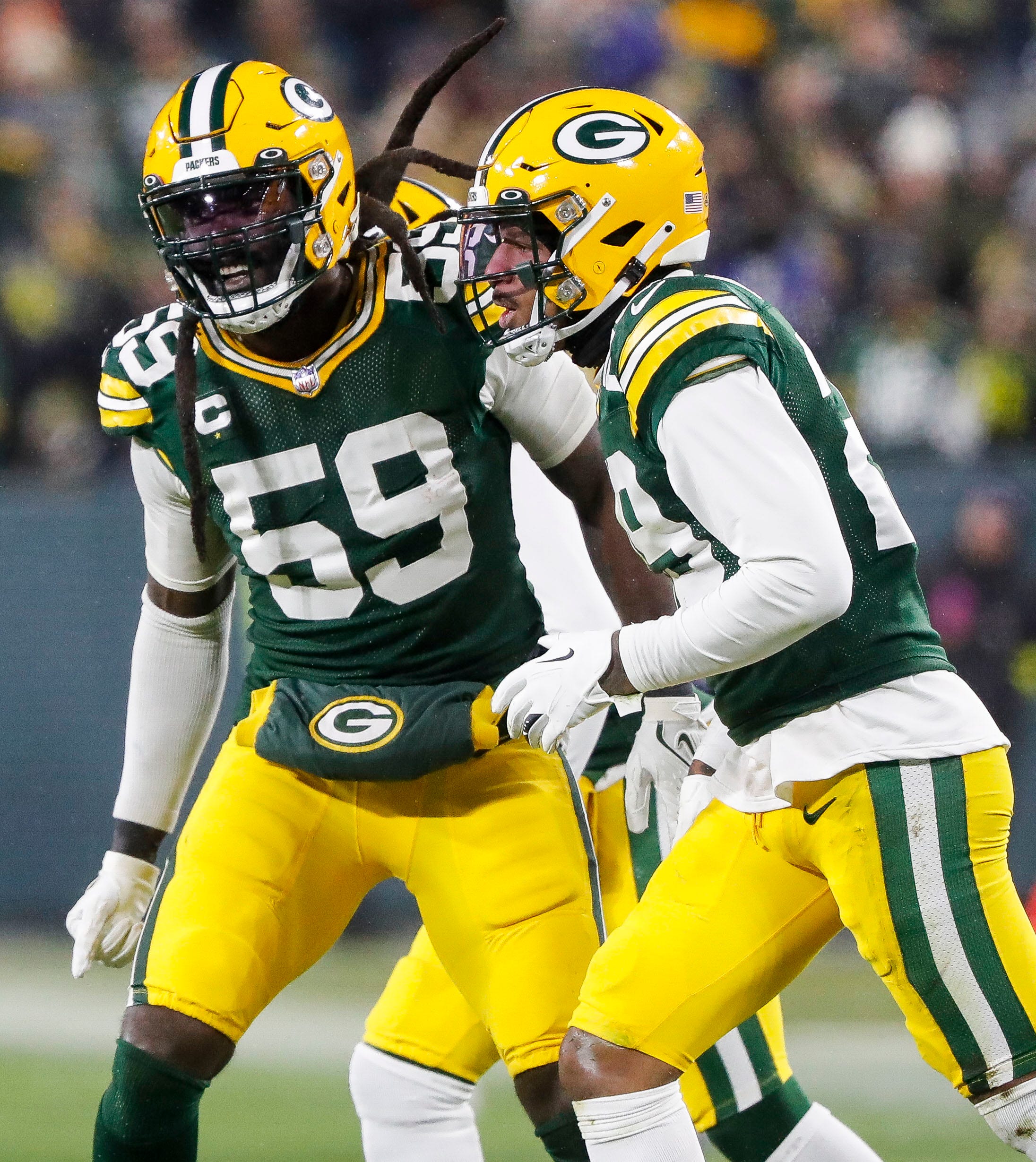 Green Bay Packers linebacker De'Vondre Campbell (59) and cornerback Rasul Douglas (29) celebrate after making a third-down stop against the Los Angeles Rams on Monday, December 19, 2022, at Lambeau Field in Green Bay, Wis. The Packers won the game, 24-12.Tork Mason/USA TODAY NETWORK-Wisconsin