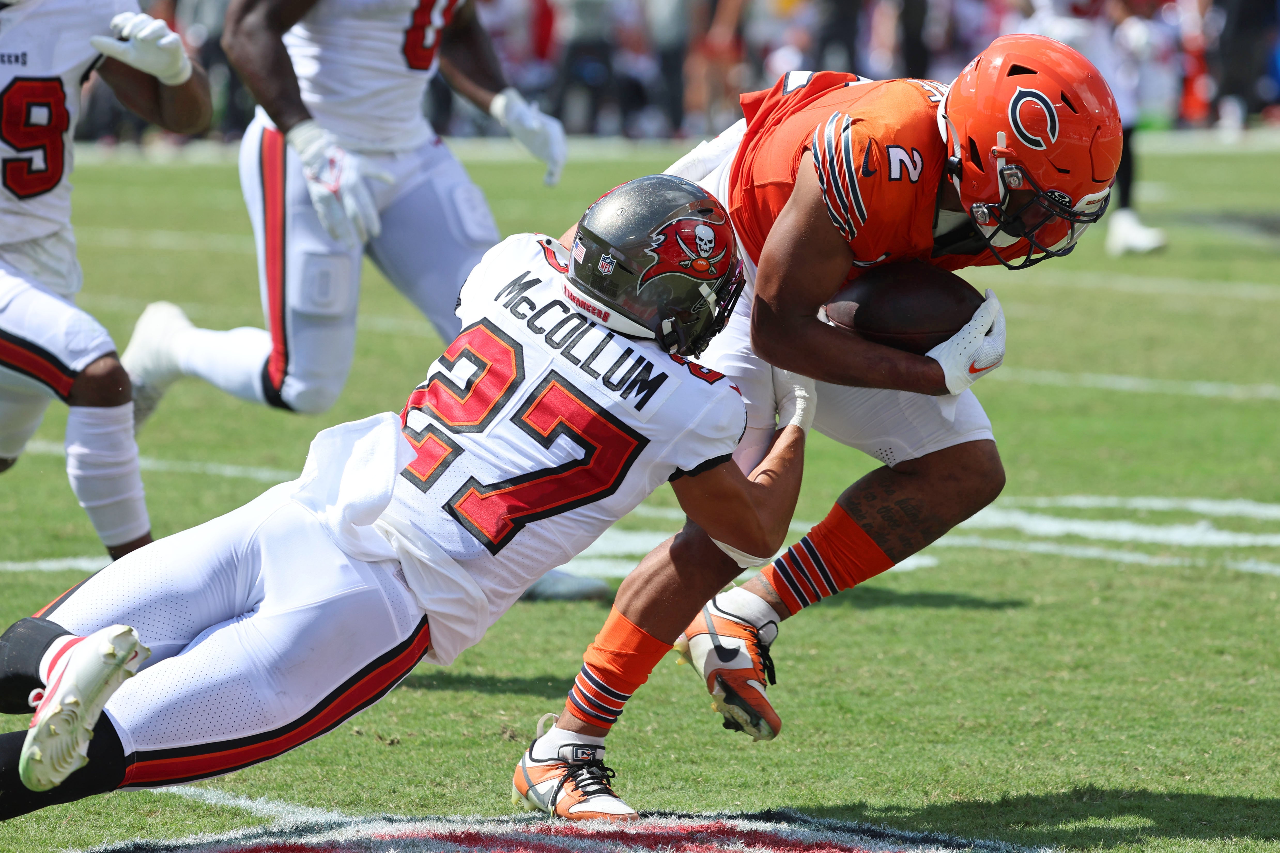 Sep 17, 2023; Tampa, Florida, USA; Tampa Bay Buccaneers cornerback Zyon McCollum (27) attempts to tackle Chicago Bears wide receiver DJ Moore (2) during the second half at Raymond James Stadium. Mandatory Credit: Kim Klement Neitzel-USA TODAY Sports