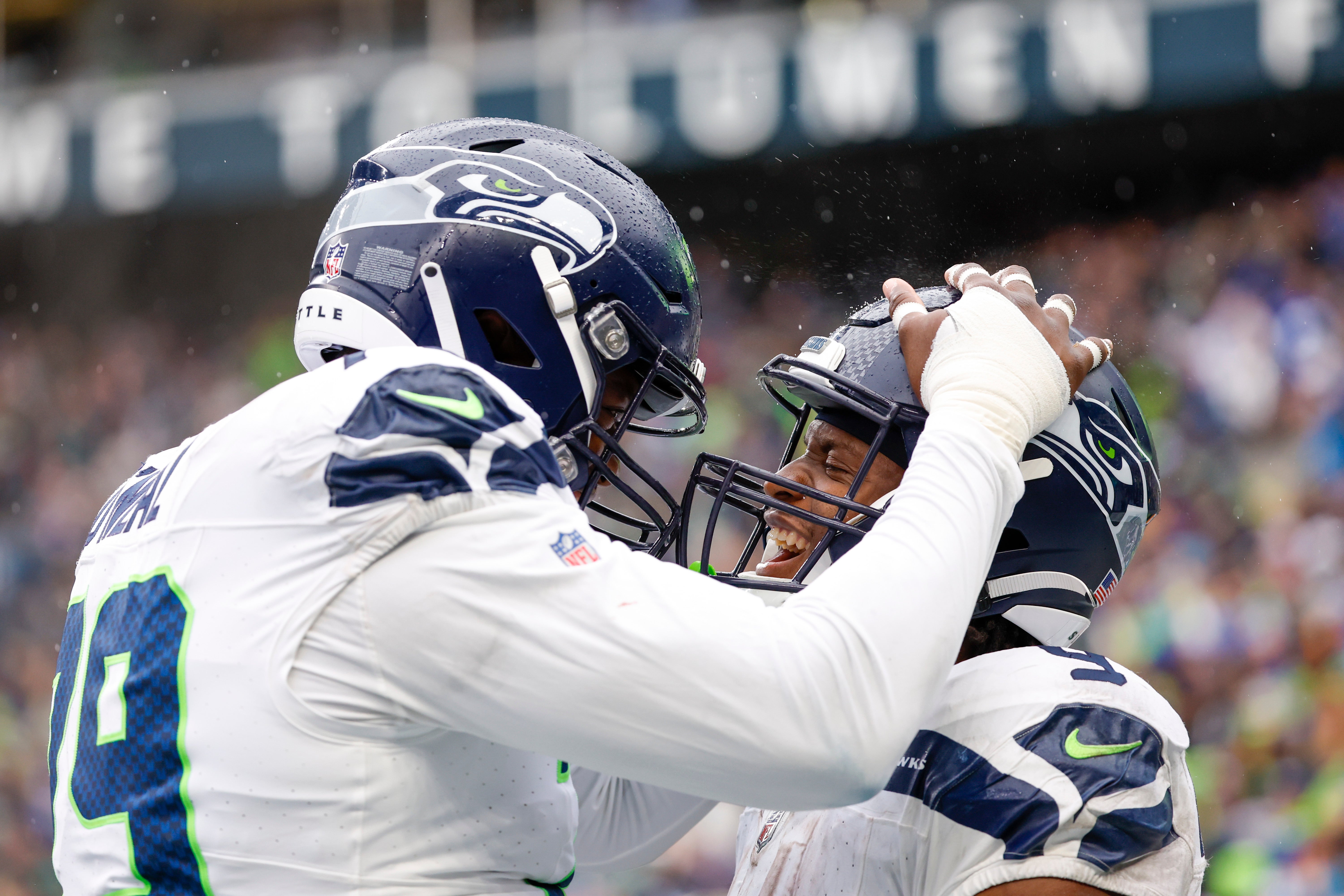 Sep 24, 2023; Seattle, Washington, USA; Seattle Seahawks running back Kenneth Walker III (9) celebrates with offensive tackle Raiqwon O'Neal (79) after rushing for a touchdown against the Carolina Panthers during the fourth quarter at Lumen Field. Mandatory Credit: Joe Nicholson-USA TODAY Sports