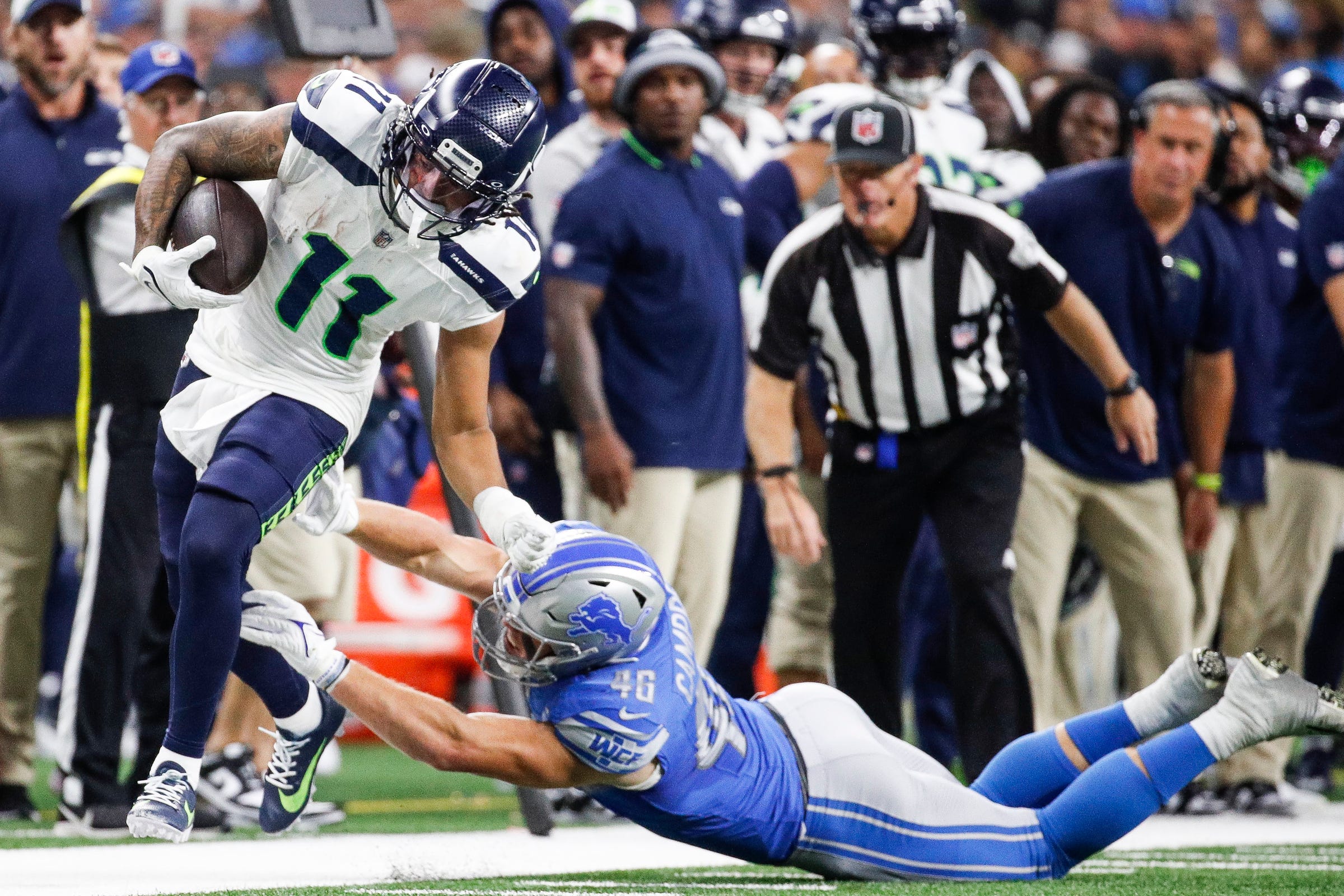 Detroit Lions linebacker Jack Campbell (46) tackles Seattle Seahawks wide receiver Jaxon Smith-Njigba (11) during the second half at Ford Field in Detroit on Sunday, Sept. 17, 2023.