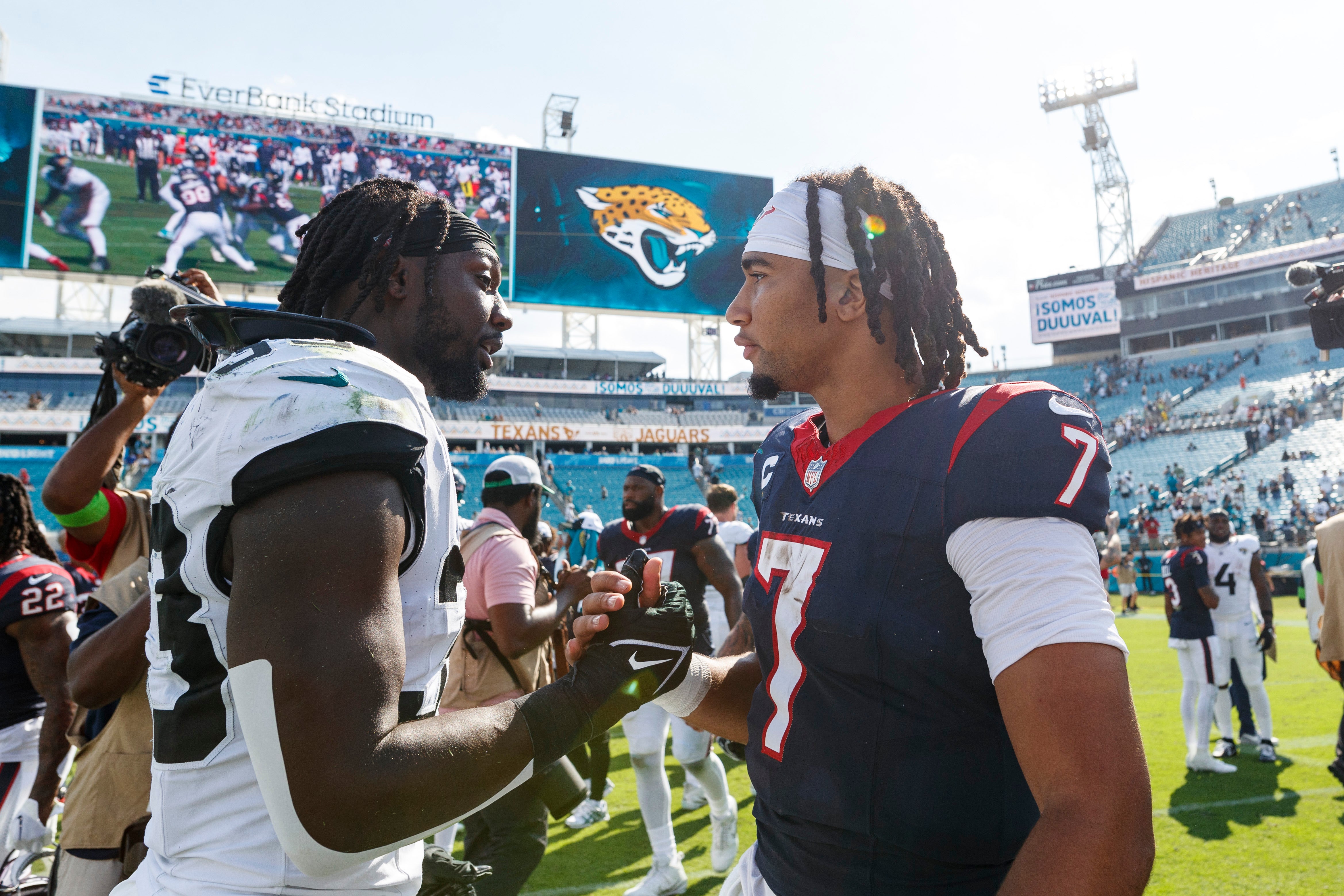 Sep 24, 2023; Jacksonville, Florida, USA; Jacksonville Jaguars linebacker Devin Lloyd (33) and Houston Texans quarterback C.J. Stroud (7) after the game at EverBank Stadium. Mandatory Credit: Morgan Tencza-USA TODAY Sports