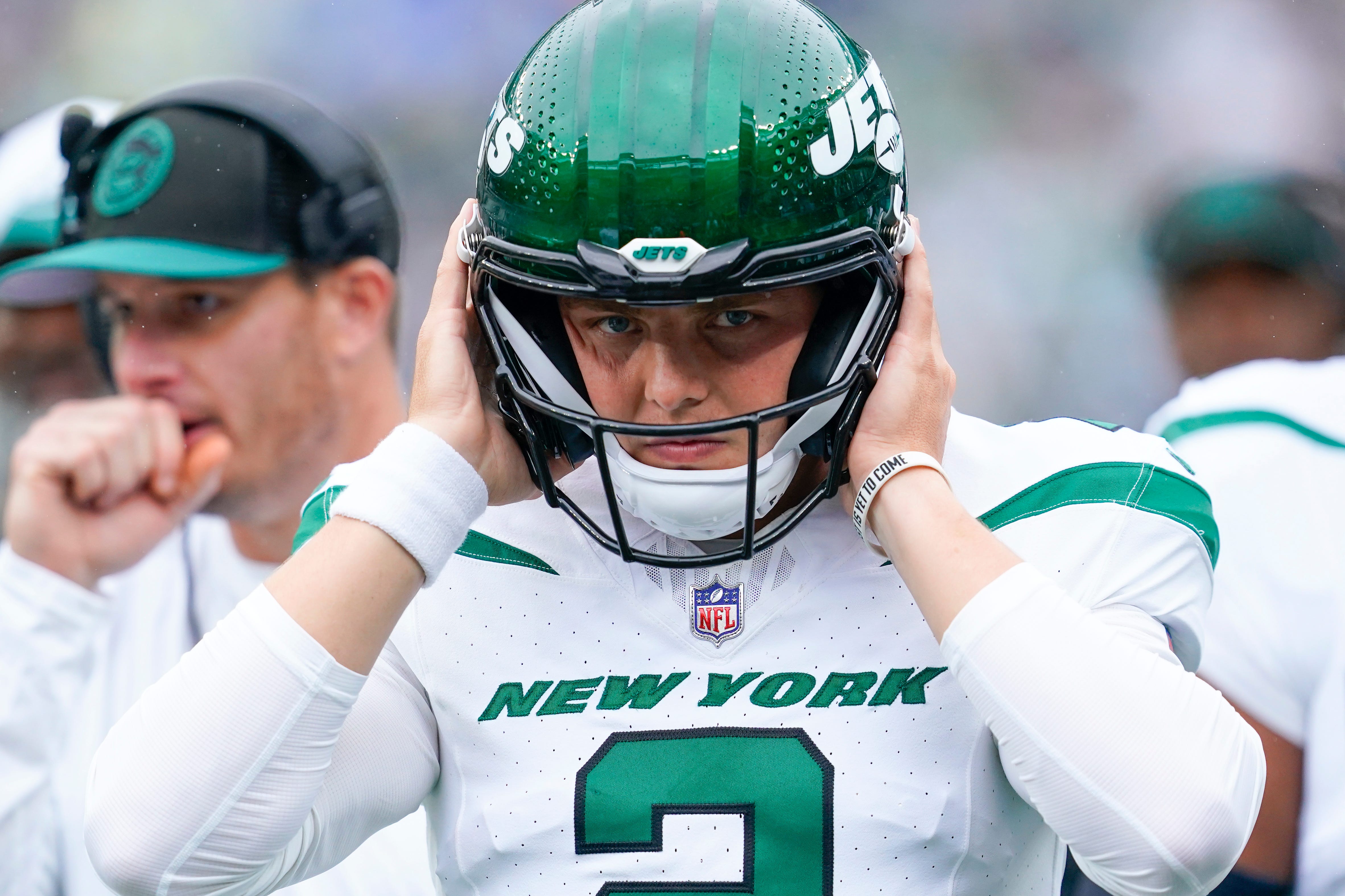 New York Jets quarterback Zach Wilson (2) puts on his helmet before walking onto the field to face the New England Patriots at MetLife Stadium on Sunday, Sept. 24, 2023, in East Rutherford.  Danielle Parhizkaran/NorthJersey.com / USA TODAY NETWORK