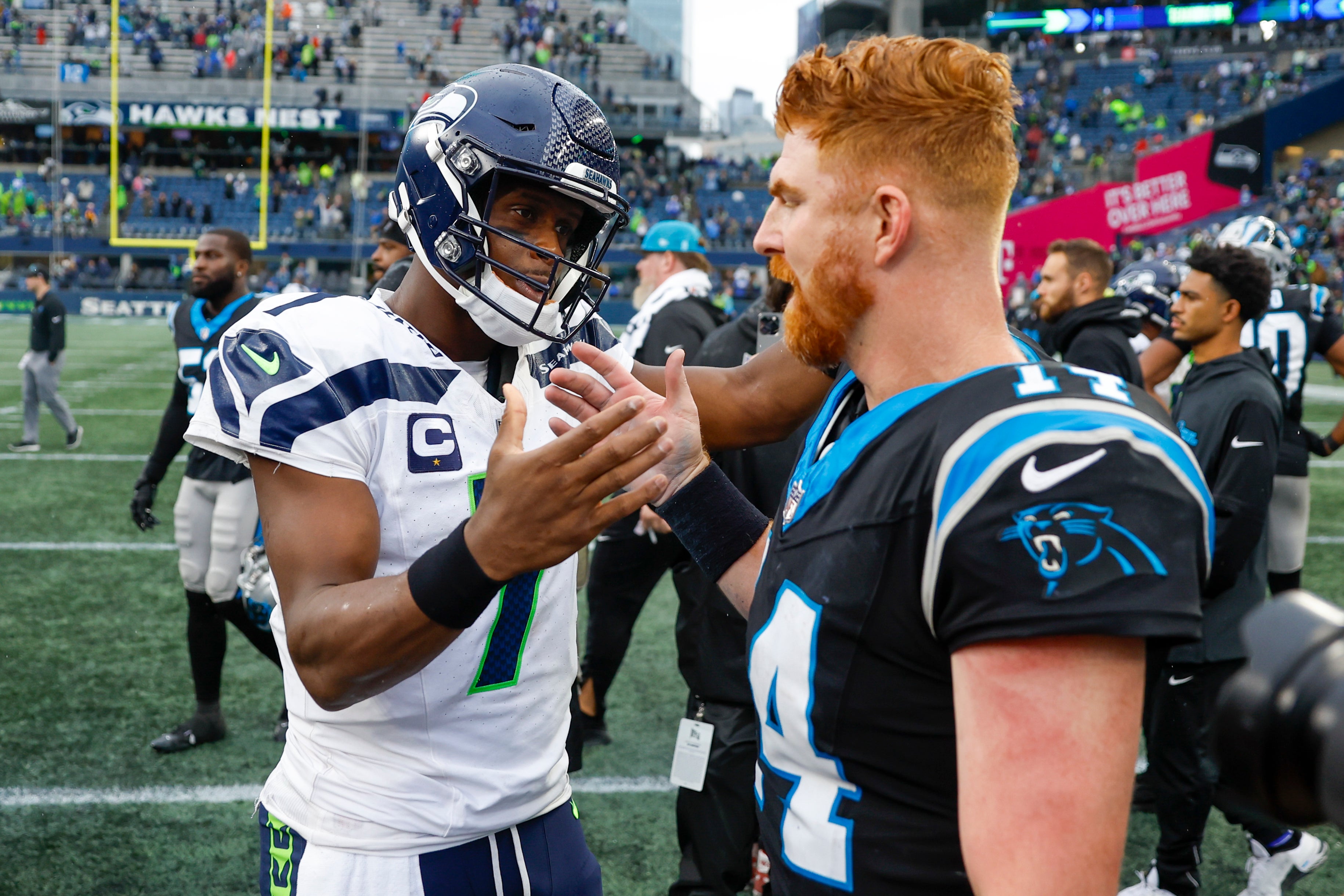 Sep 24, 2023; Seattle, Washington, USA; Seattle Seahawks quarterback Geno Smith (7) shakes hands with Carolina Panthers quarterback Andy Dalton (14) following a 37-27 Seattle victory at Lumen Field. Mandatory Credit: Joe Nicholson-USA TODAY Sports