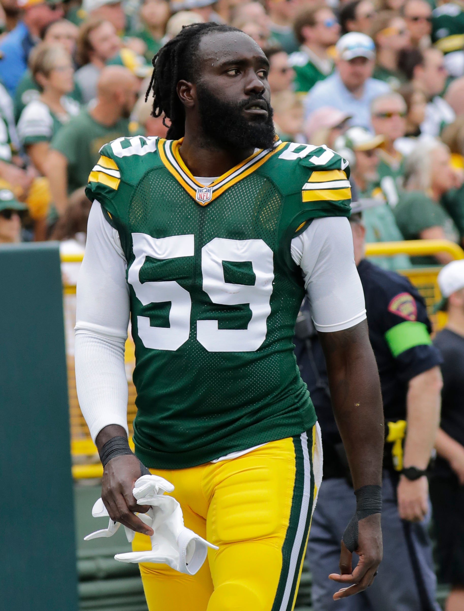 Sep 24, 2023; Green Bay, Wisconsin, USA; Green Bay Packers linebacker De'Vondre Campbell (59) leaves the field after getting injured against the New Orleans Saints at Lambeau Field. Mandatory Credit: Dan Powers-USA TODAY Sports
