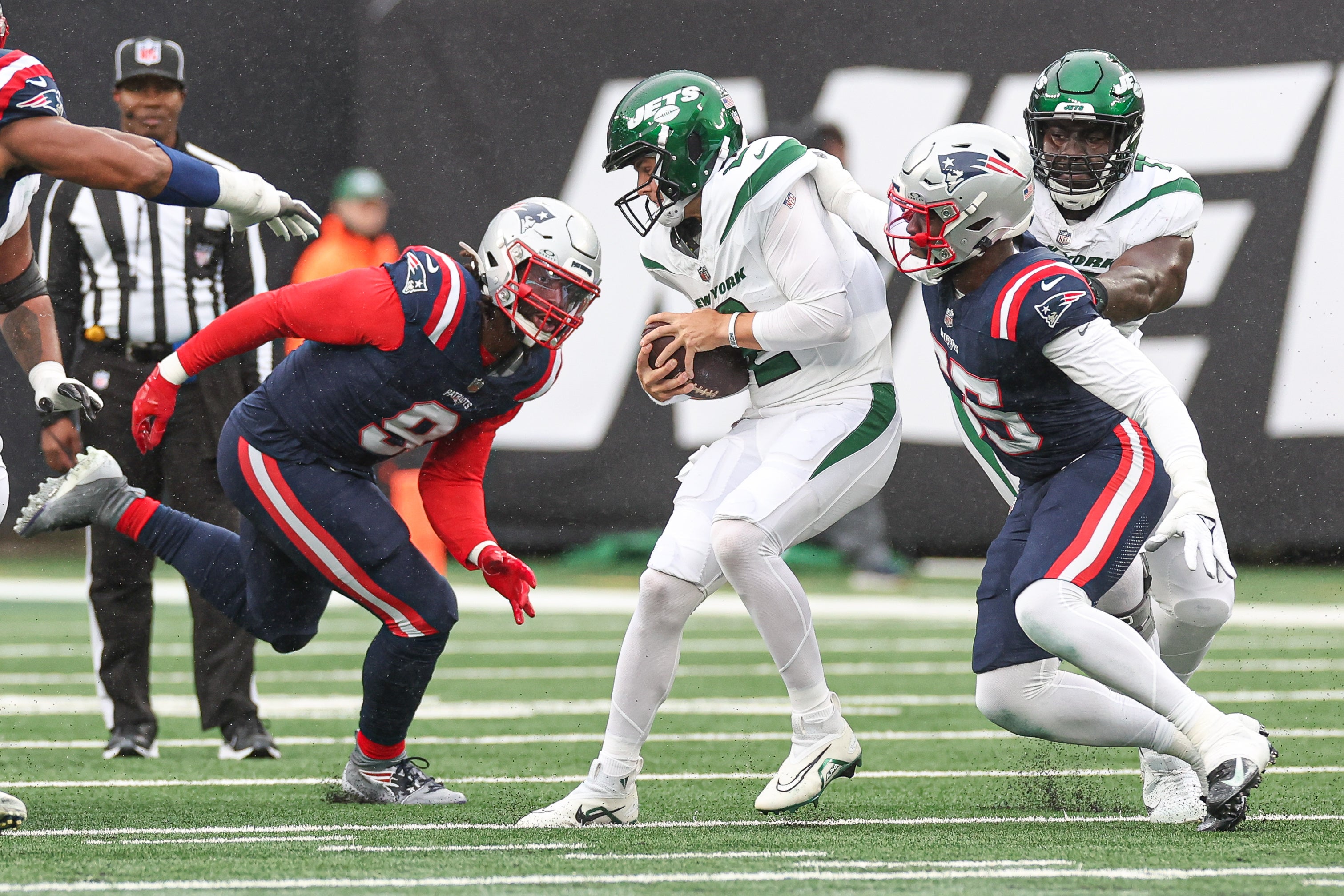 New York Jets quarterback Zach Wilson (2) is sacked by New England Patriots linebacker Josh Uche (55) and linebacker Matthew Judon (9) during the first half at MetLife Stadium. Mandatory Credit: Vincent Carchietta-USA TODAY Sports