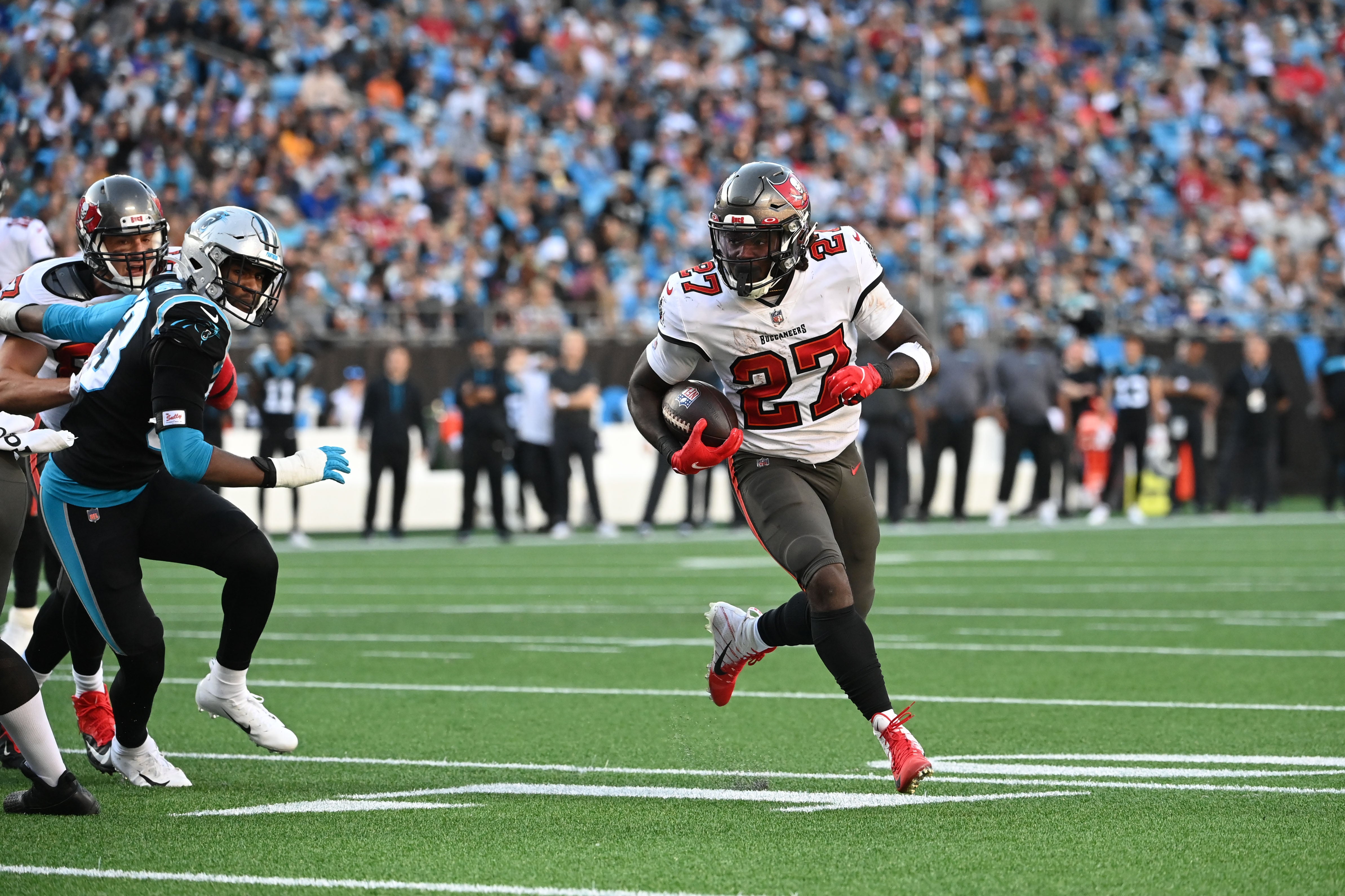Dec 26, 2021; Charlotte, North Carolina, USA; Tampa Bay Buccaneers running back Ronald Jones (27) runs for a touchdown as Carolina Panthers defensive end Brian Burns (53) defends in the third quarter at Bank of America Stadium.