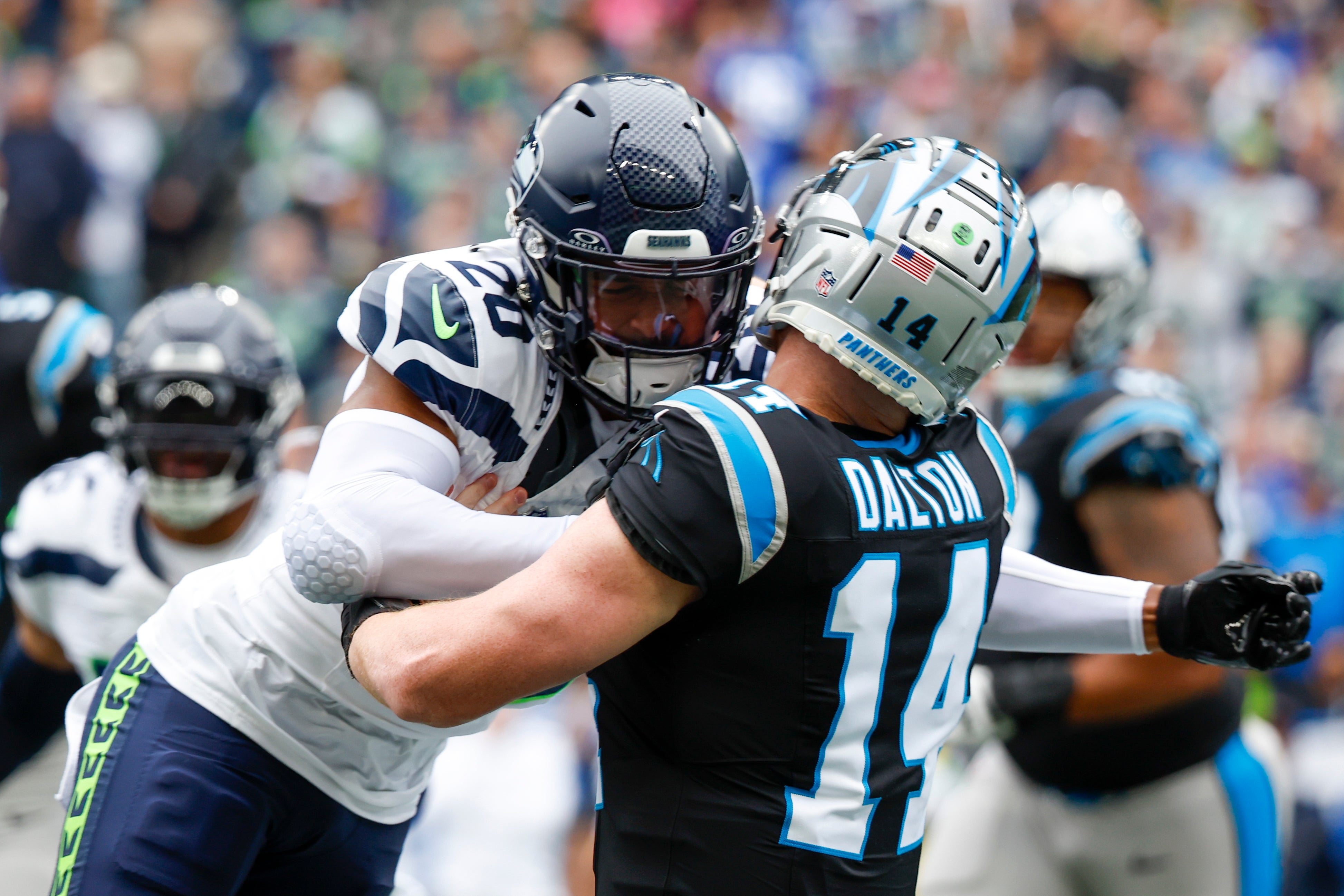 Sep 24, 2023; Seattle, Washington, USA; Seattle Seahawks safety Julian Love (20) hits Carolina Panthers quarterback Andy Dalton (14) following a pass attempt by Dalton during the first quarter at Lumen Field. Love was given a penalty on the play. Mandatory Credit: Joe Nicholson-USA TODAY Sports.