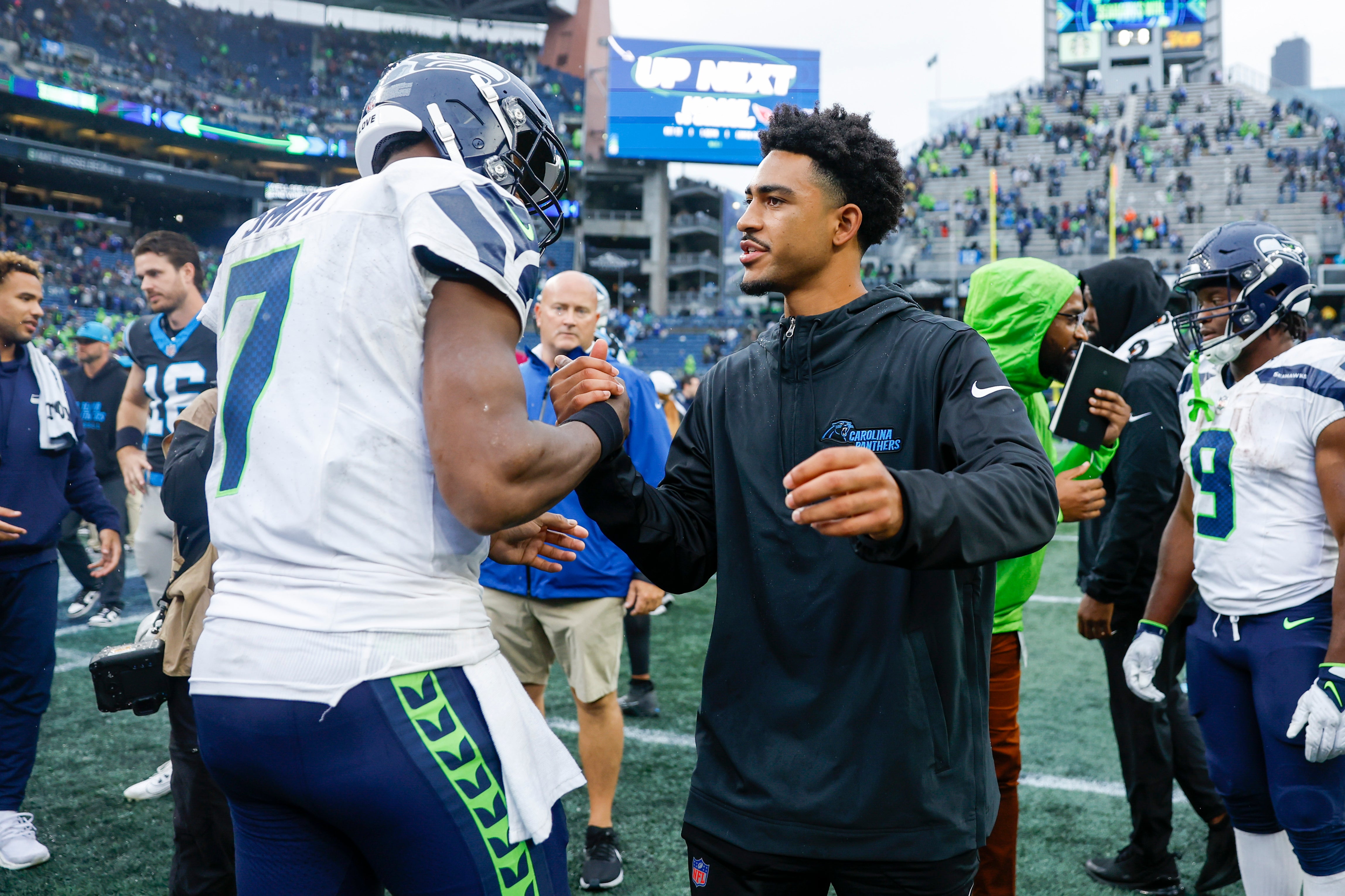 Sep 24, 2023; Seattle, Washington, USA; Seattle Seahawks quarterback Geno Smith (7) shakes hands with Carolina Panthers quarterback Bryce Young (9, right) following a 37-27 Seattle victory at Lumen Field. Mandatory Credit: Joe Nicholson-USA TODAY Sports.