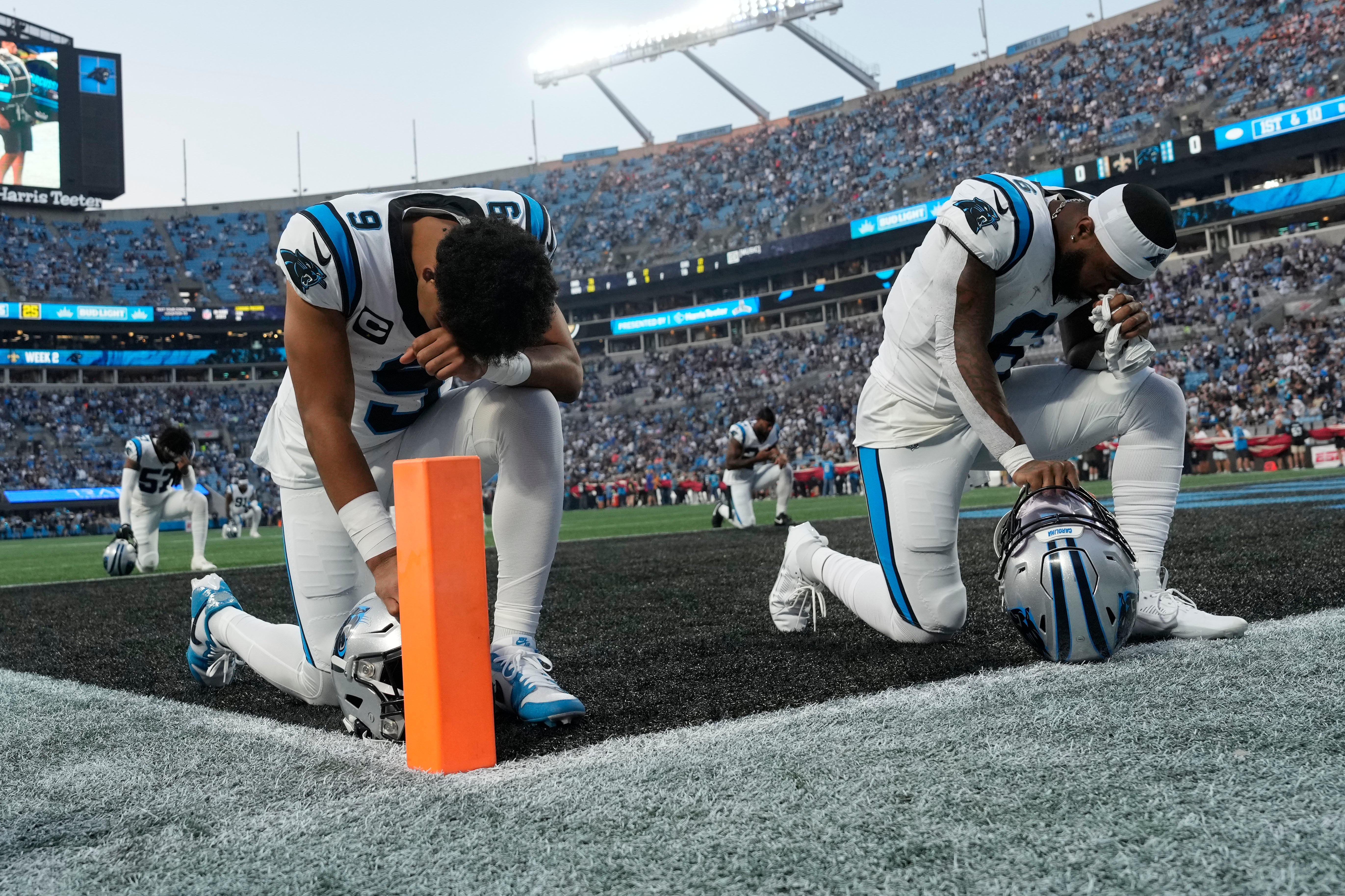 Sep 18, 2023; Charlotte, North Carolina, USA; Carolina Panthers quarterback Bryce Young (9) and running back Miles Sanders (6) kneel before the game at Bank of America Stadium. Mandatory Credit: Bob Donnan-USA TODAY Sports.