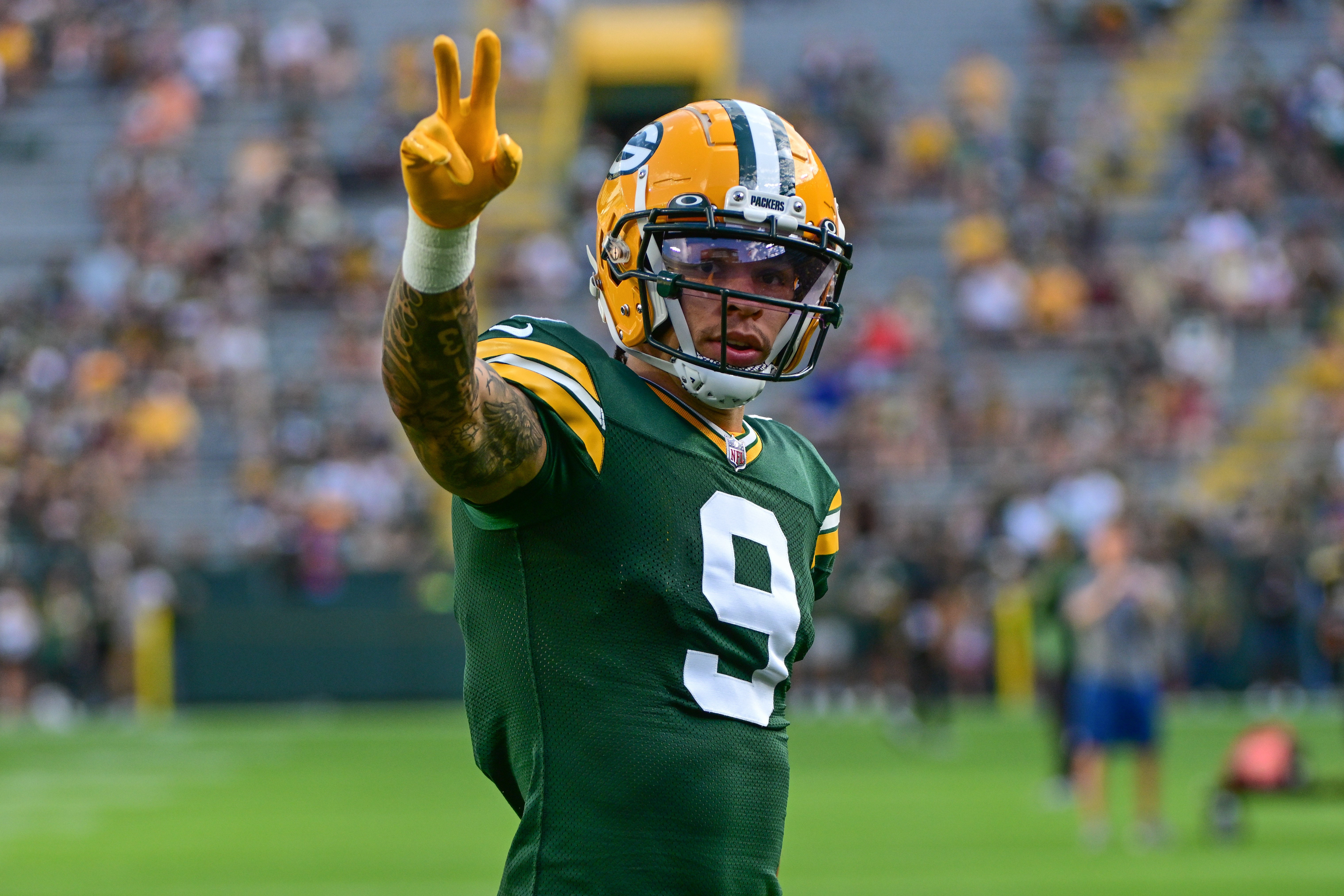 Aug 19, 2023; Green Bay, Wisconsin, USA; Green Bay Packers wide receiver Christian Watson (9) waves to fans before game against the New England Patriots at Lambeau Field.