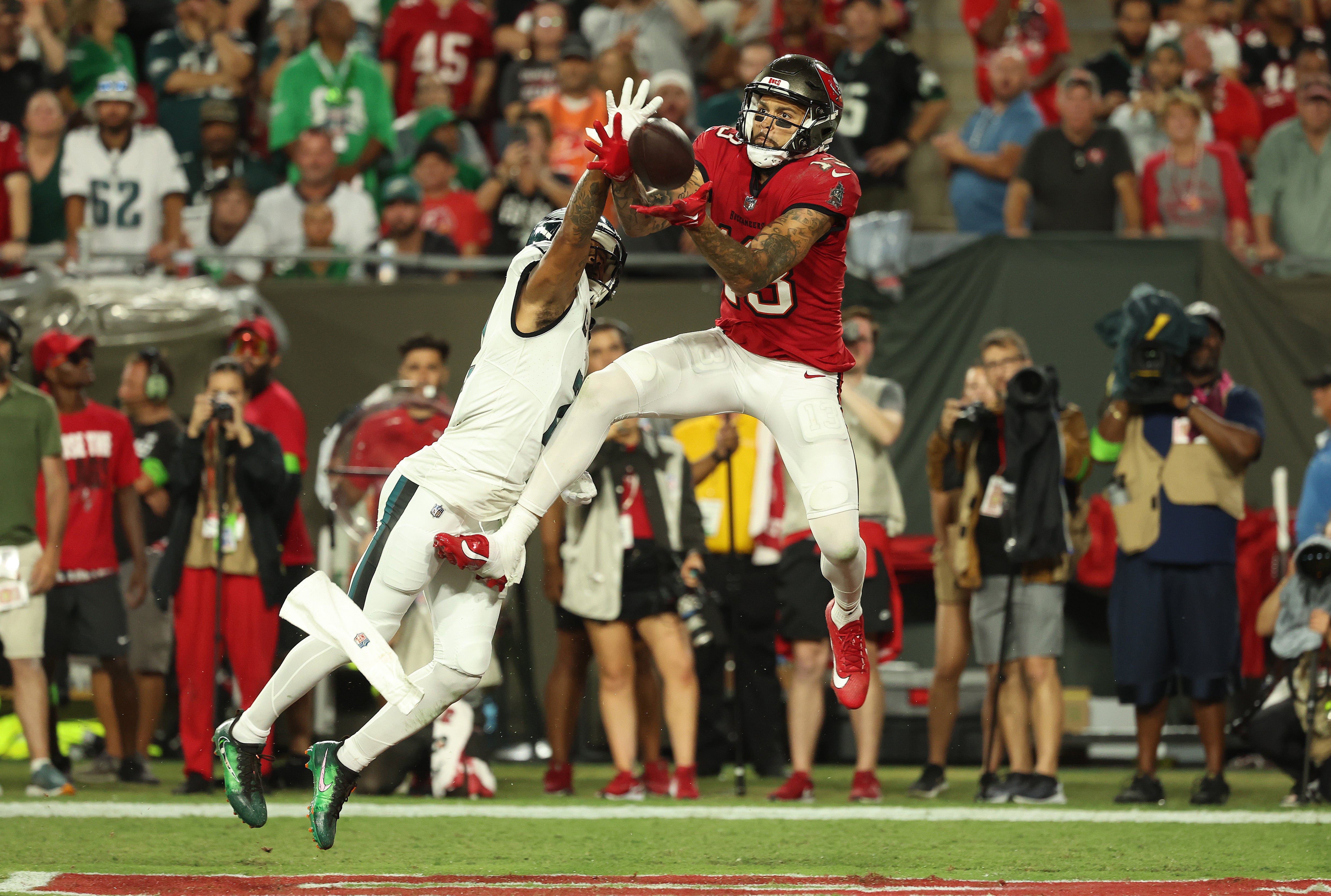 Sep 25, 2023; Tampa, Florida, USA; Tampa Bay Buccaneers wide receiver Mike Evans (13) catches the ball over Philadelphia Eagles cornerback Darius Slay (2) for a touchdown during the second half at Raymond James Stadium. Mandatory Credit: Kim Klement Neitzel-USA TODAY Sports