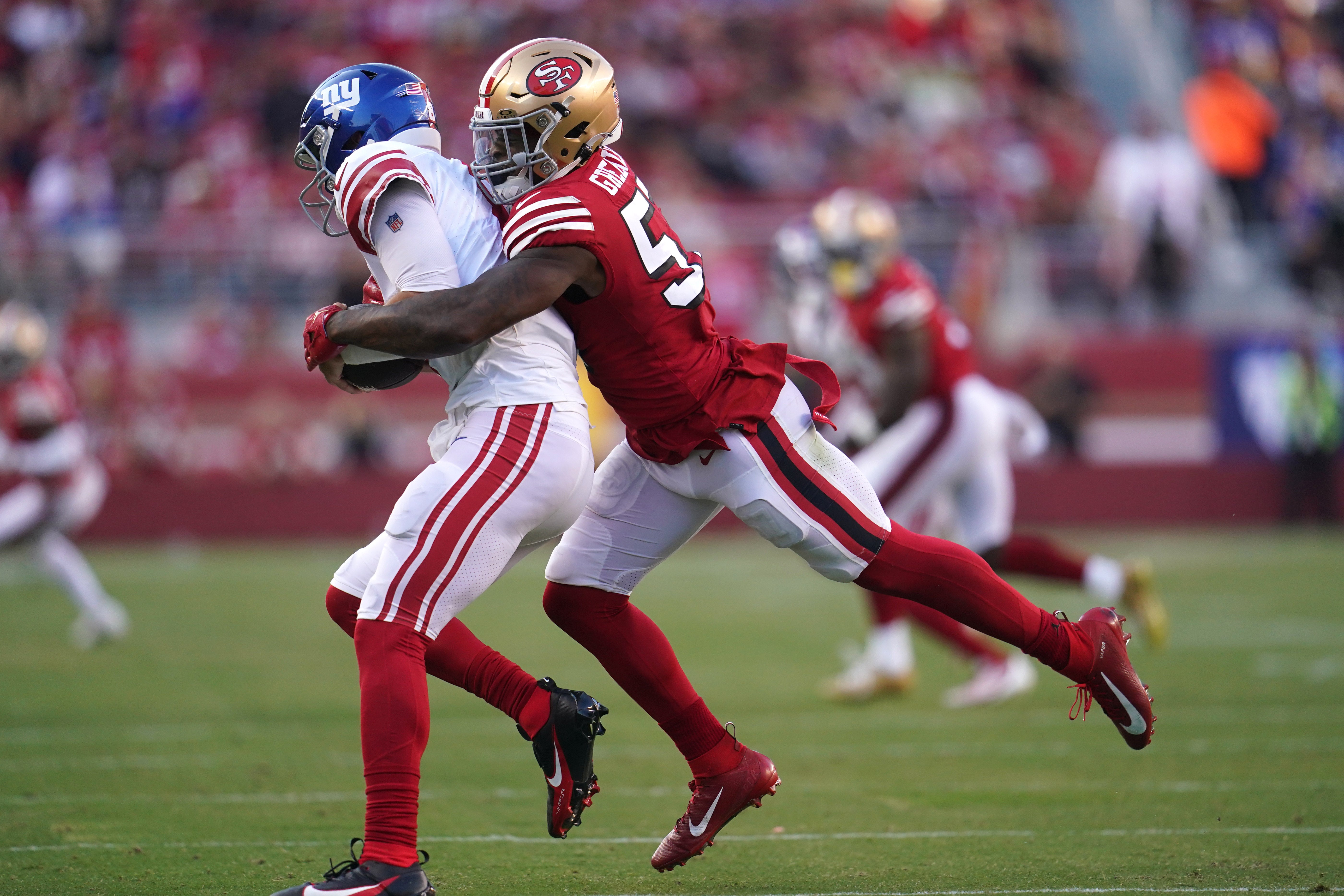 Sep 21, 2023; Santa Clara, California, USA; New York Giants quarterback Daniel Jones (8) is tackled by San Francisco 49ers linebacker Dre Greenlaw (57) in the second quarter at Levi's Stadium.