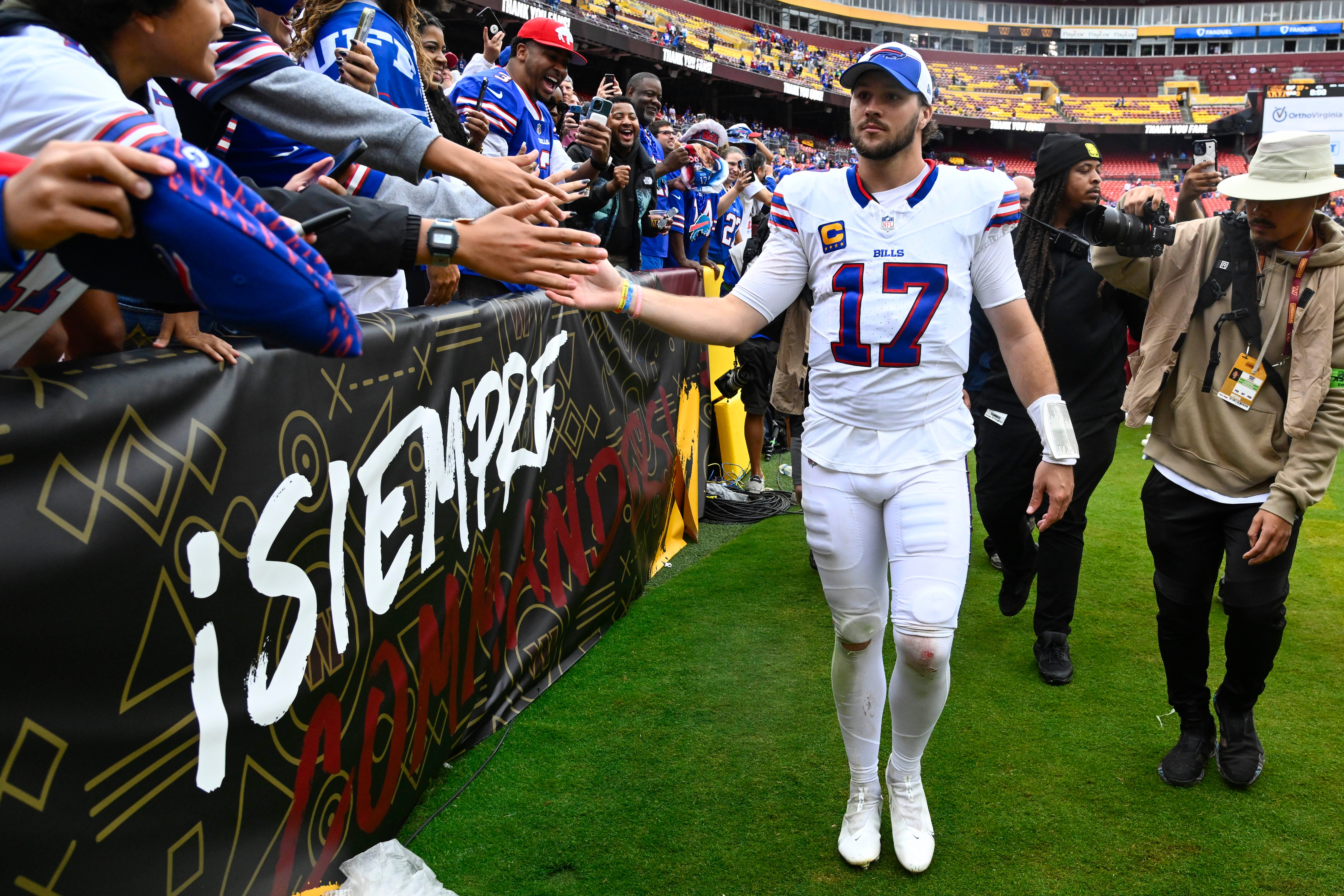 Buffalo Bills QB Josh Allen celebrating with the Bills Mafia after their victory over the Washington Commanders