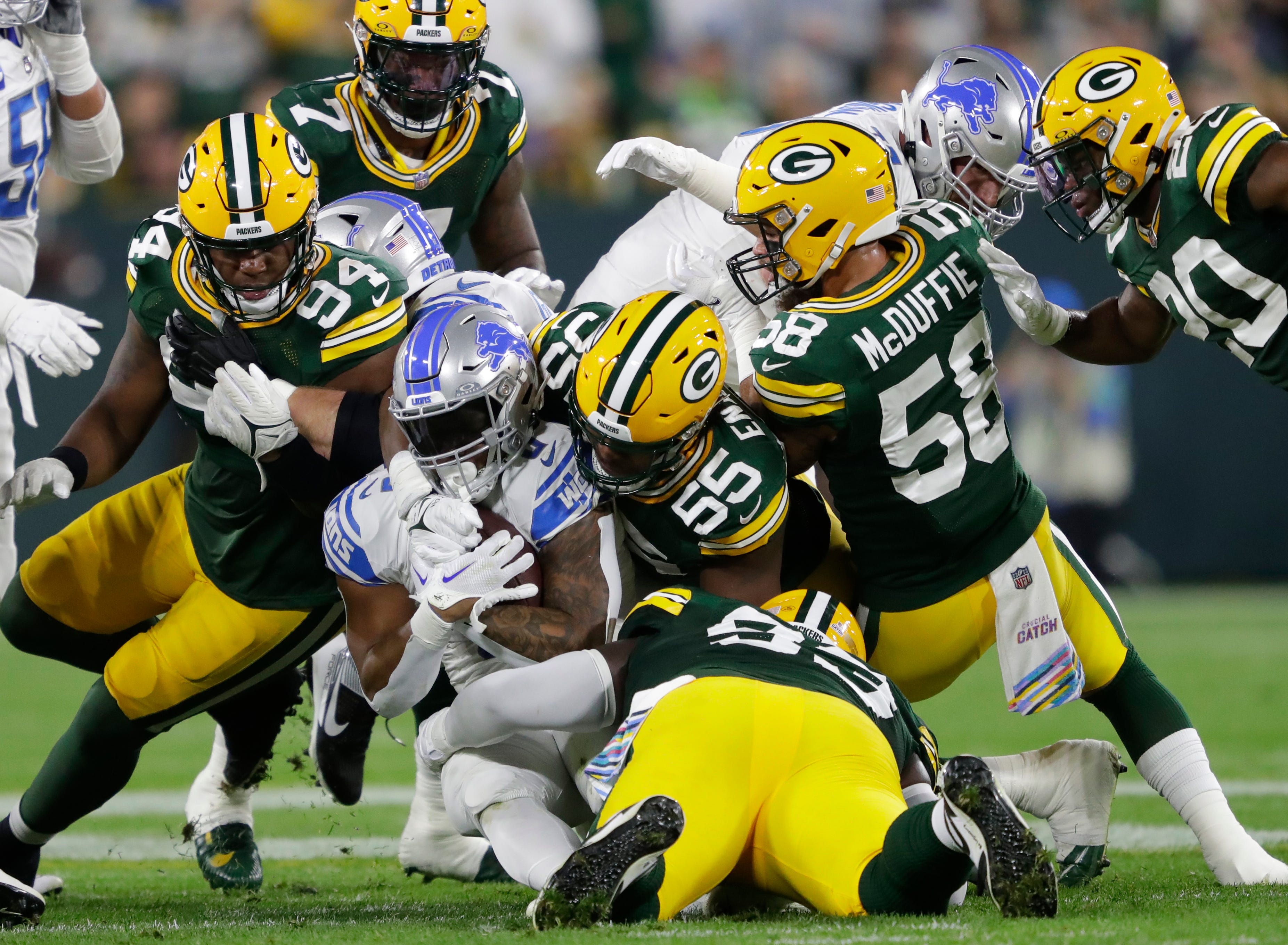 Detroit Lions running back David Montgomery (5) is tackled by Green Bay Packers linebacker Kingsley Enagbare (55) during their football game Thursday, September 28, 2023, at Lambeau Field in Green Bay, Wis.