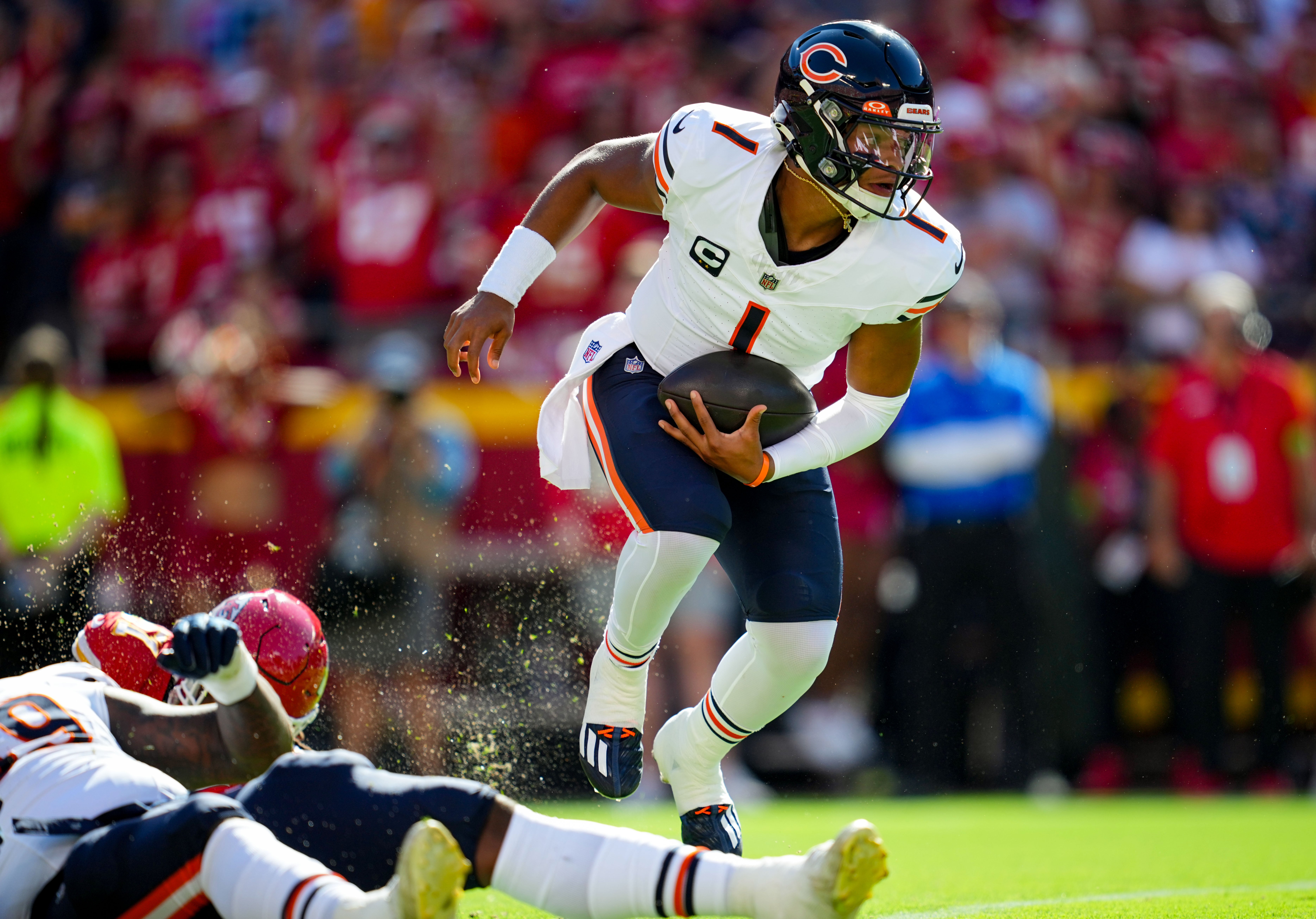 Sep 24, 2023; Kansas City, Missouri, USA; Chicago Bears quarterback Justin Fields (1) runs the ball against Kansas City Chiefs defensive end Mike Danna (51) during the first half at GEHA Field at Arrowhead Stadium.