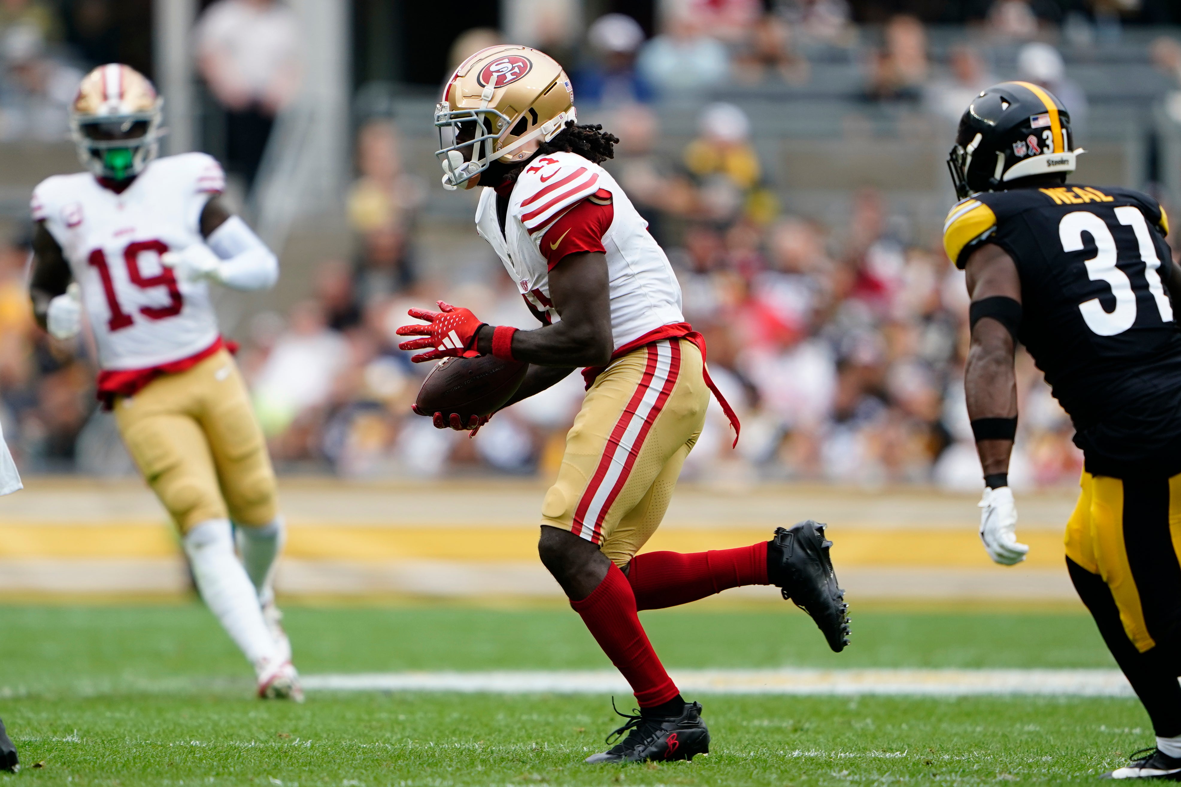 Sep 10, 2023; Pittsburgh, Pennsylvania, USA; San Francisco 49ers wide receiver Brandon Aiyuk (11) runs with the ball after making a catch against the Pittsburgh Steelers during the first half at Acrisure Stadium.