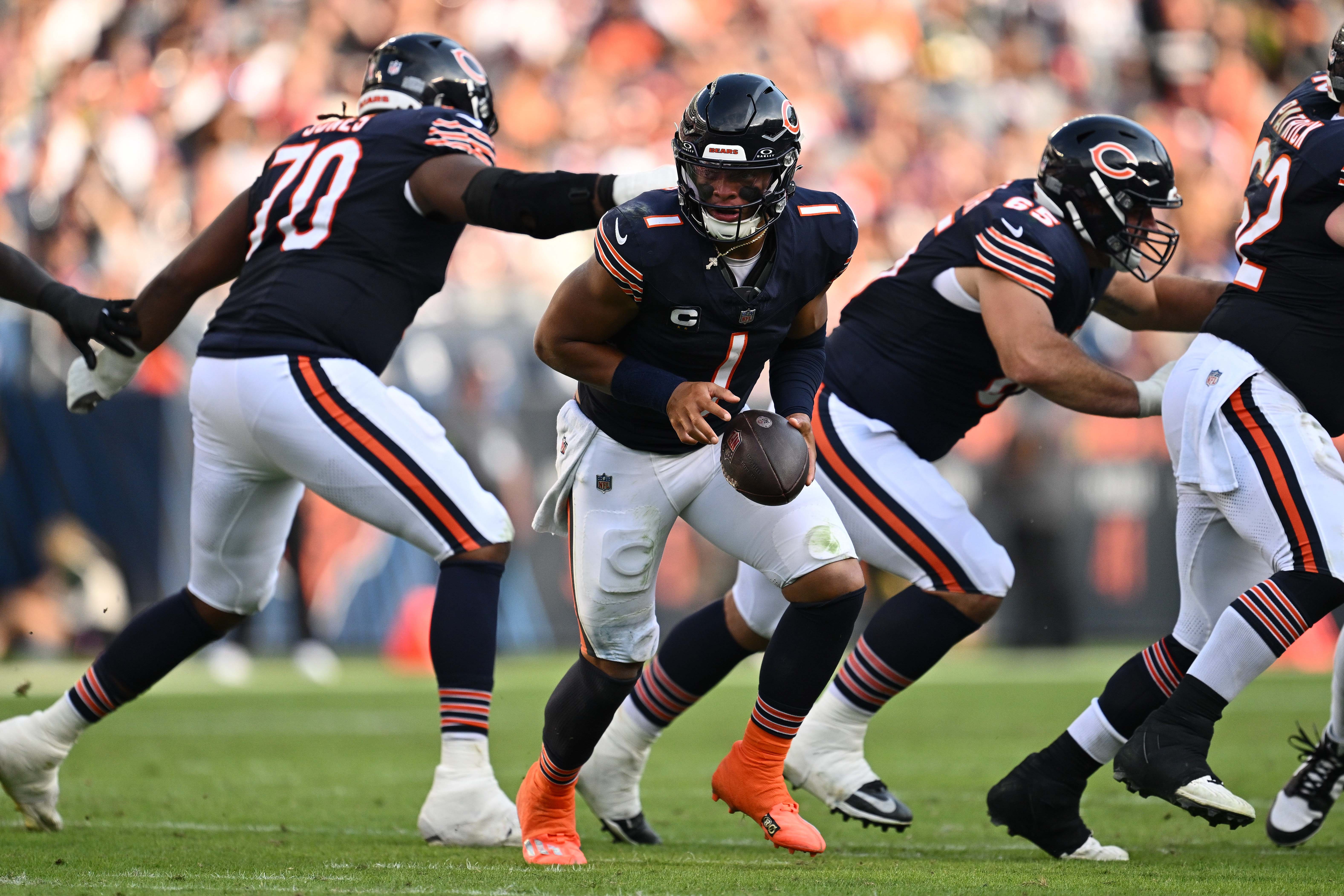 Sep 10, 2023; Chicago, Illinois, USA; Chicago Bears quarterback Justin Fields (1) hands off the ball against the Green Bay Packers at Soldier Field.