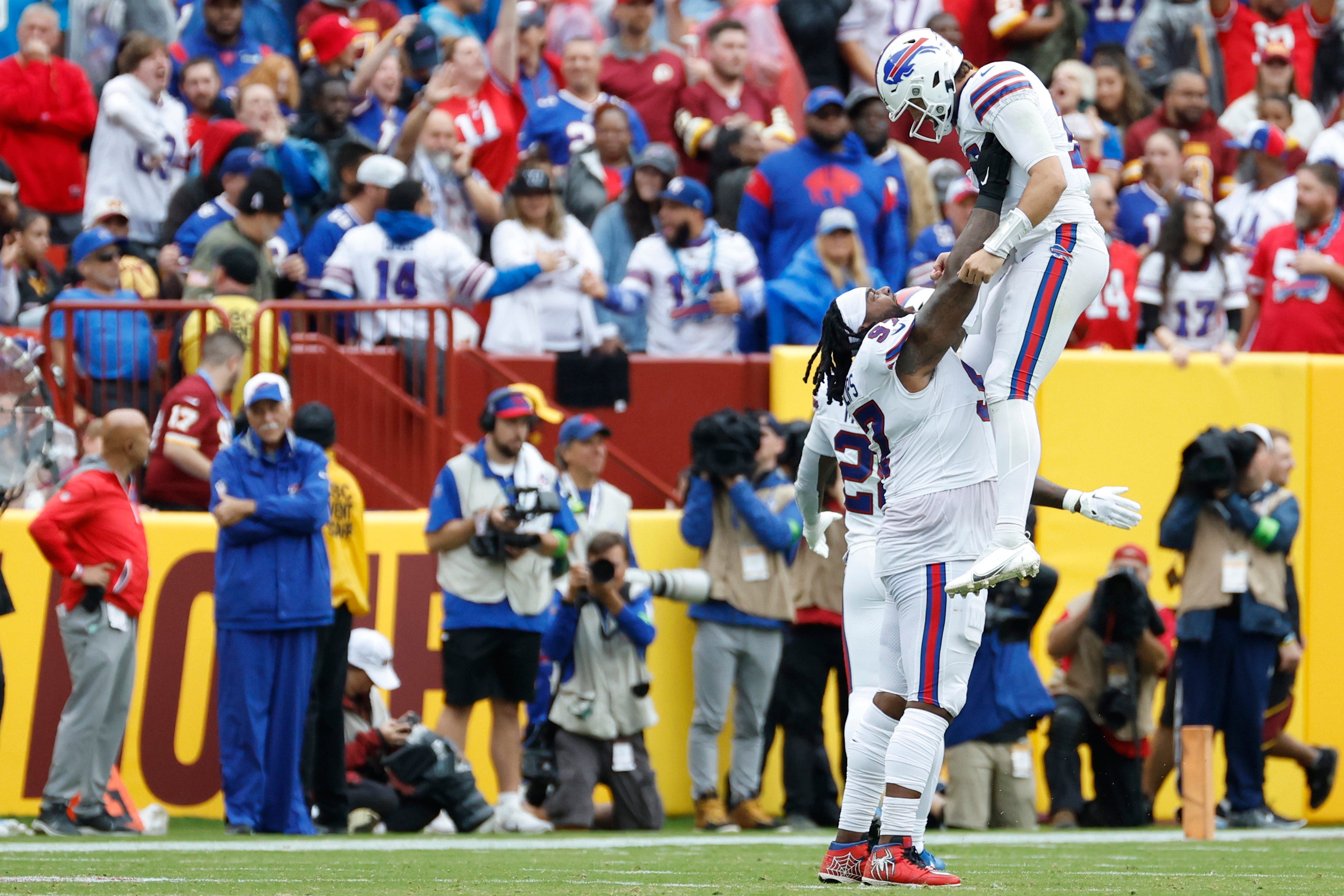 Buffalo Bills QB Josh Allen celebrates with Bills DT Jordan Phillips after scoring a touchdown against the Washington Commanders