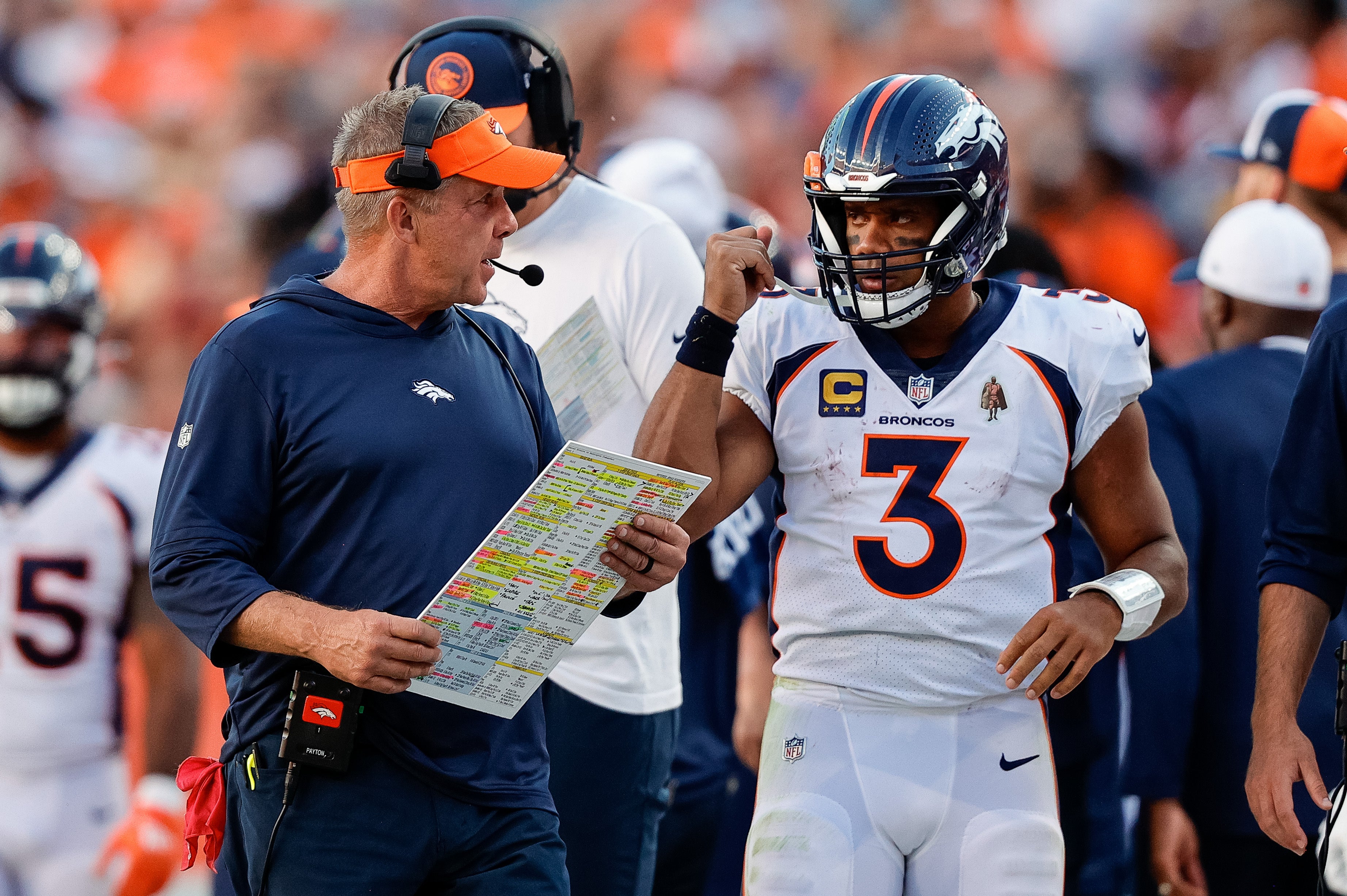 Denver Broncos head coach Sean Payton talking with QB Russell Wilson on the sideline