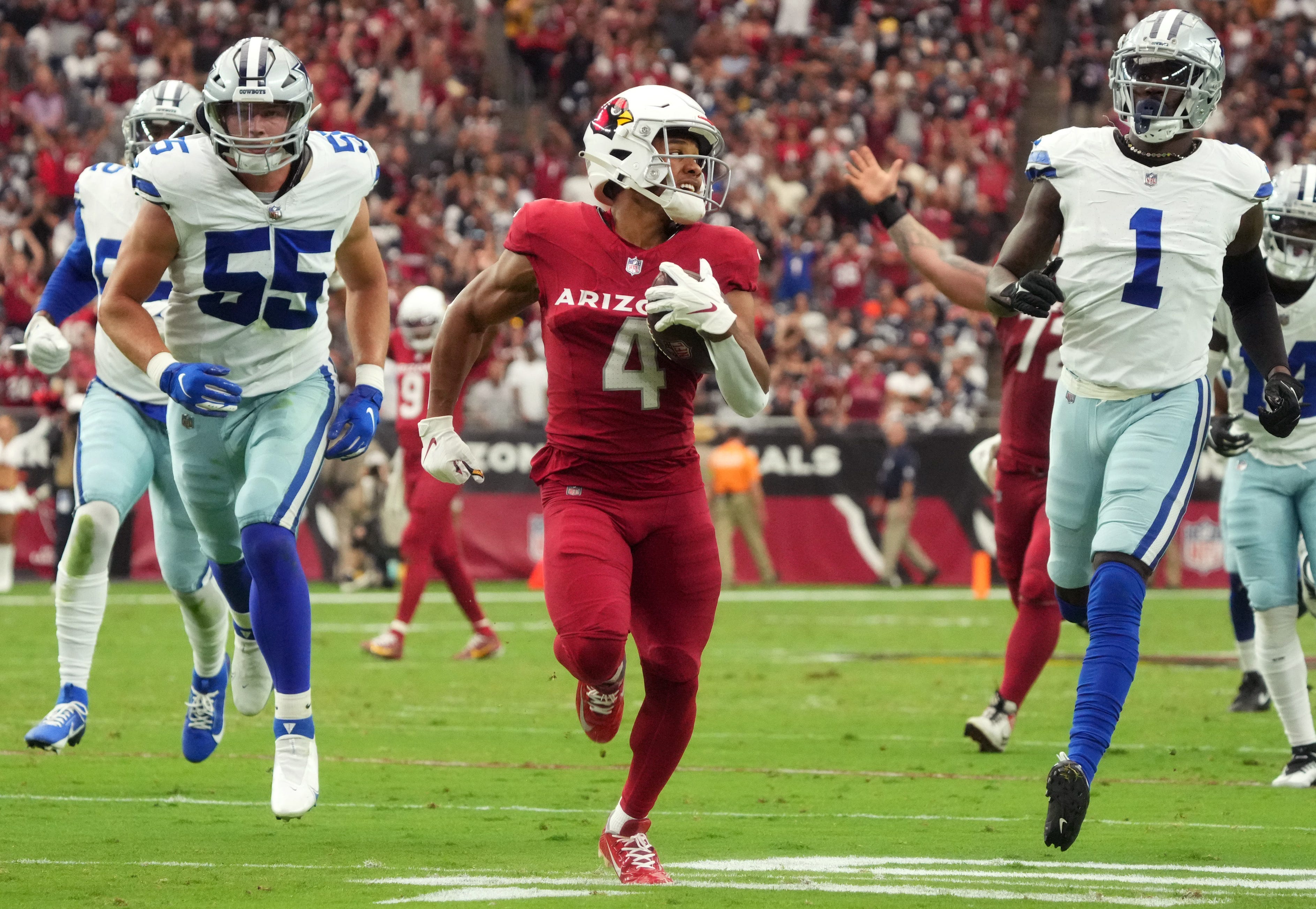 Arizona Cardinals receiver Rondale Moore (4) scores on a 45-yard reception against the Dallas Cowboys at State Farm Stadium in Glendale on Sept. 24, 2023.