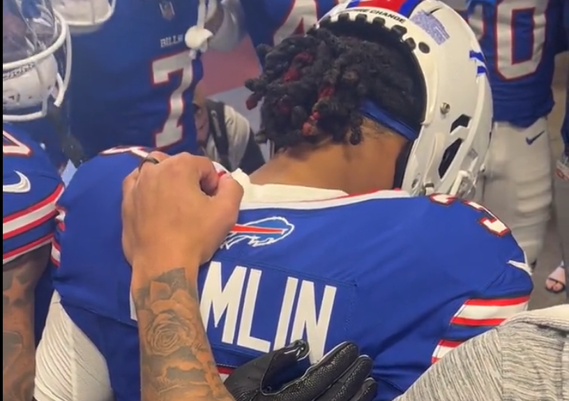 Buffalo Bills S Damar Hamlin praying with his team before the game