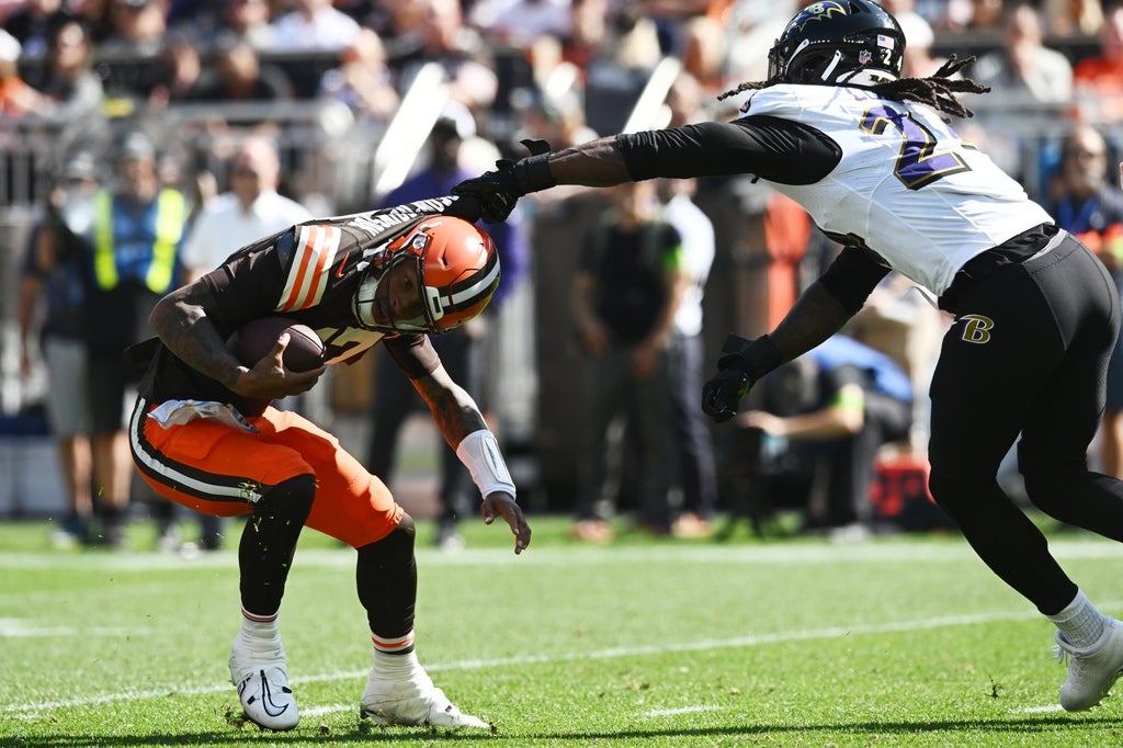 Baltimore Ravens linebacker Jadeveon Clowney (24) grabs the jersey of Cleveland Browns quarterback Dorian Thompson-Robinson (17) during the first half at Cleveland Browns Stadium.