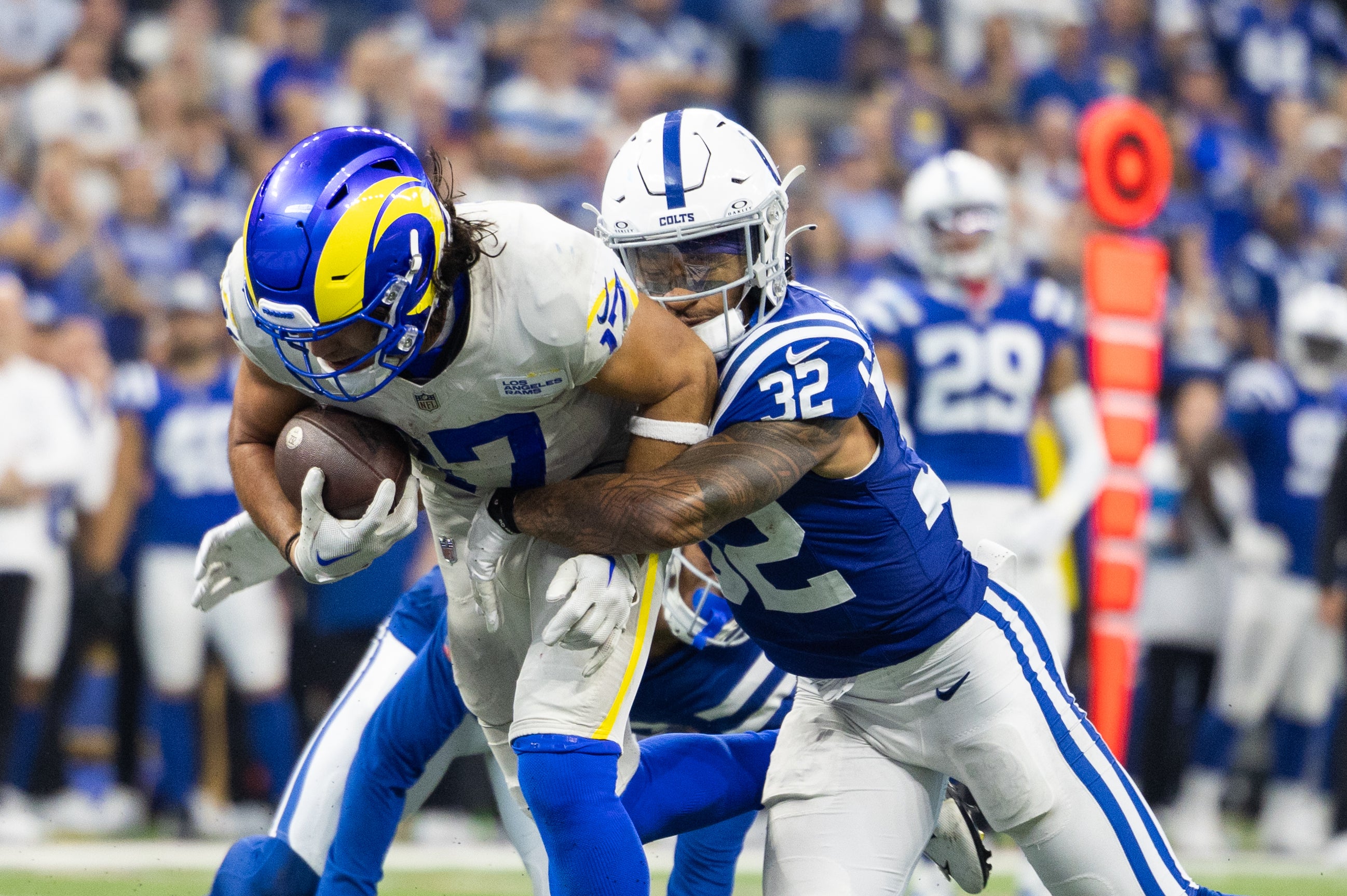 Oct 1, 2023; Indianapolis, Indiana, USA; Los Angeles Rams wide receiver Puka Nacua (17) catches and runs for a touchdown with the ball while Indianapolis Colts safety Rodney Thomas II (25) and Indianapolis Colts safety Julian Blackmon (32) defend in the overtime at Lucas Oil Stadium.
