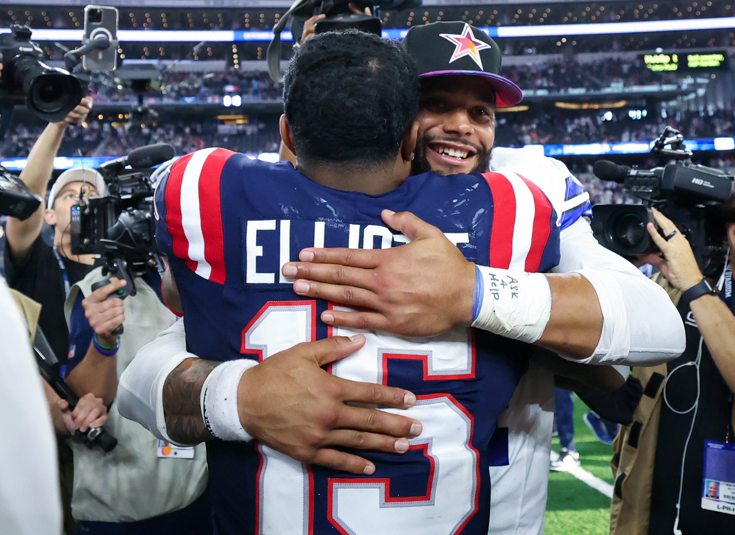 Oct 1, 2023; Arlington, Texas, USA; Dallas Cowboys quarterback Dak Prescott (4) hugs New England Patriots running back Ezekiel Elliott (15) after the game at AT&T Stadium.