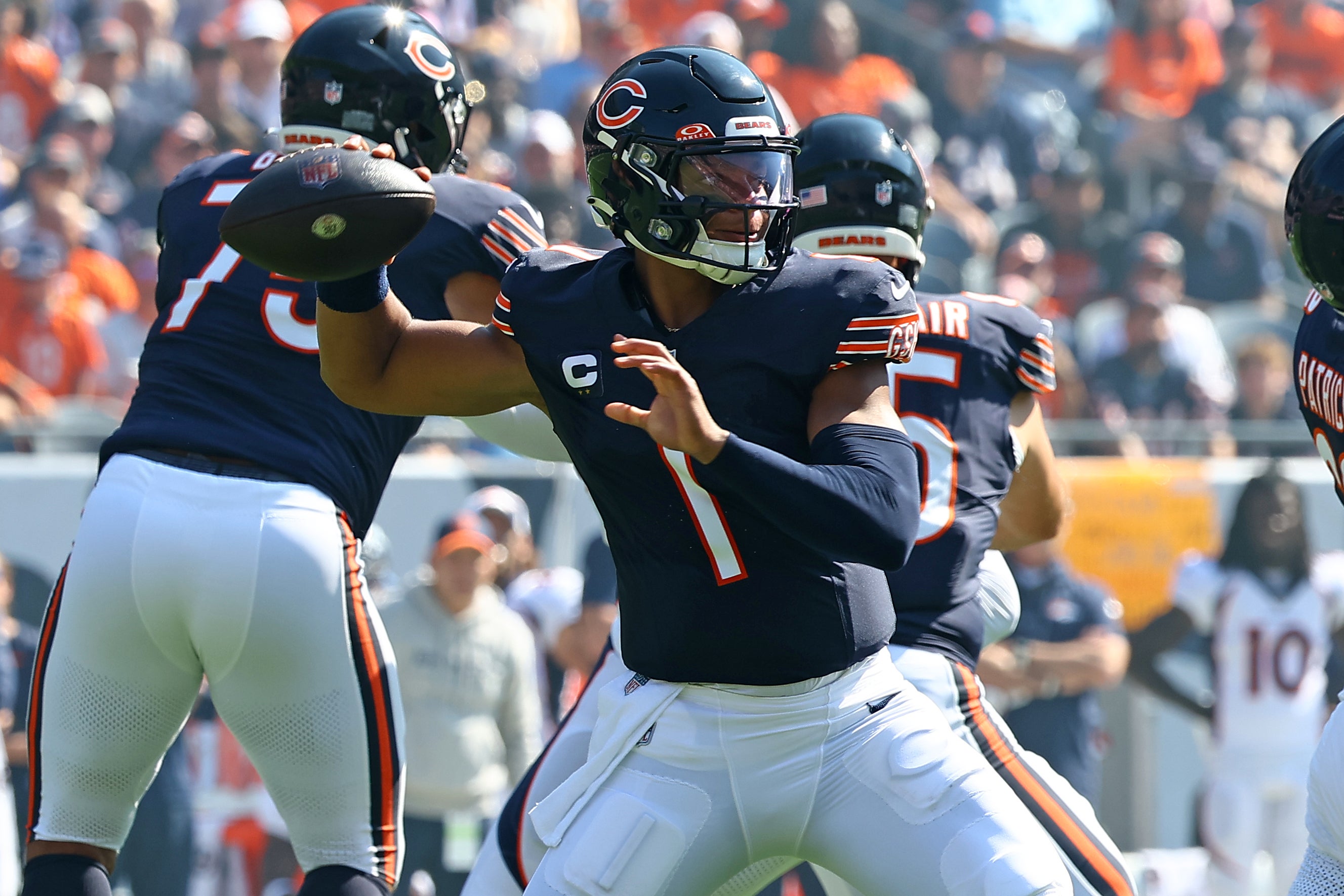 Oct 1, 2023; Chicago, Illinois, USA; Chicago Bears quarterback Justin Fields (1) drops back to pass/ against the Denver Broncos during the first half at Soldier Field.