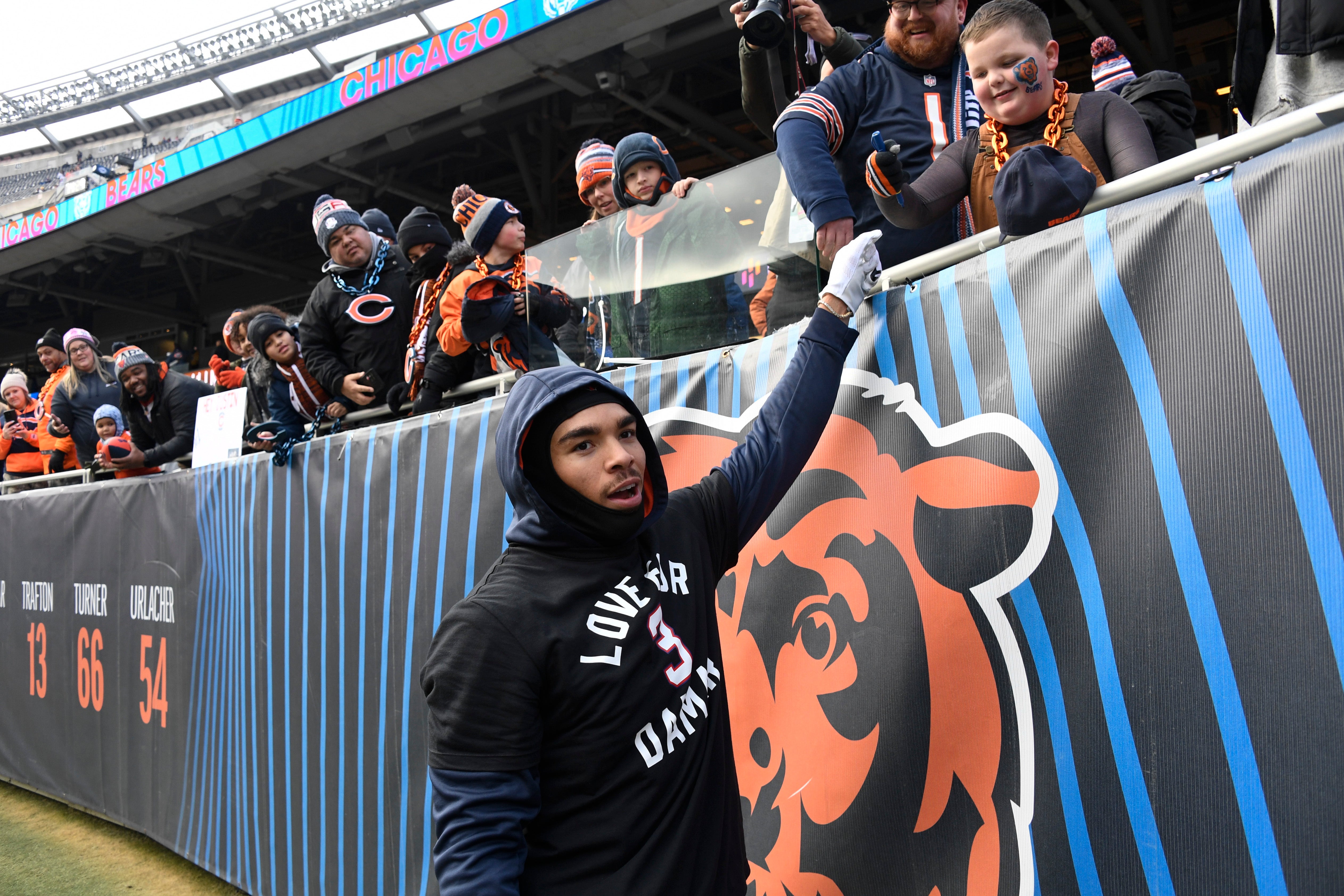 Jan 8, 2023; Chicago, Illinois, USA; Chicago Bears wide receiver Chase Claypool (10) high-fives fans before the team's game against the Minnesota Vikings at Soldier Field.
