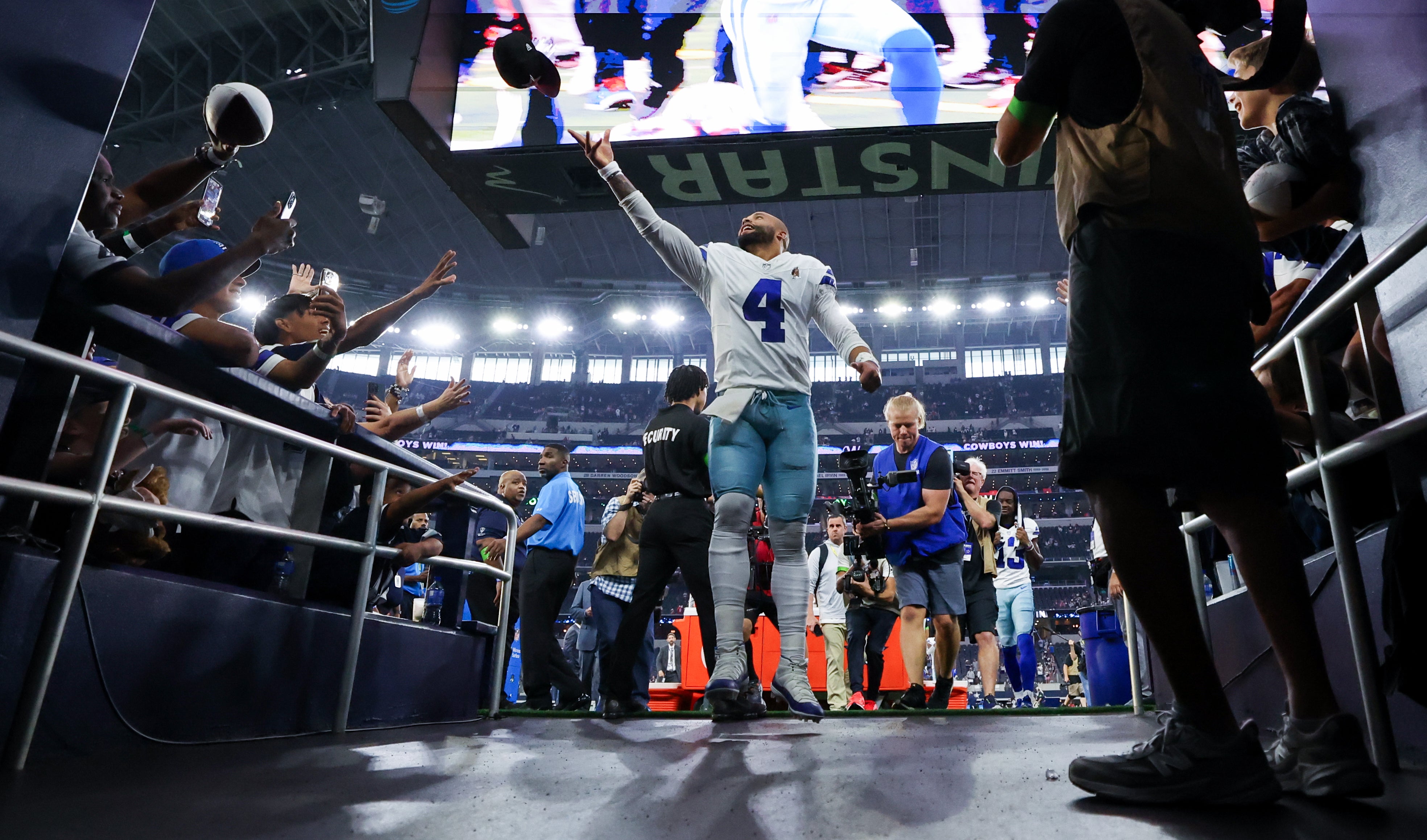 Dak Prescott tosses a football into the stands following the Dallas Cowboys win against the New England Patriots