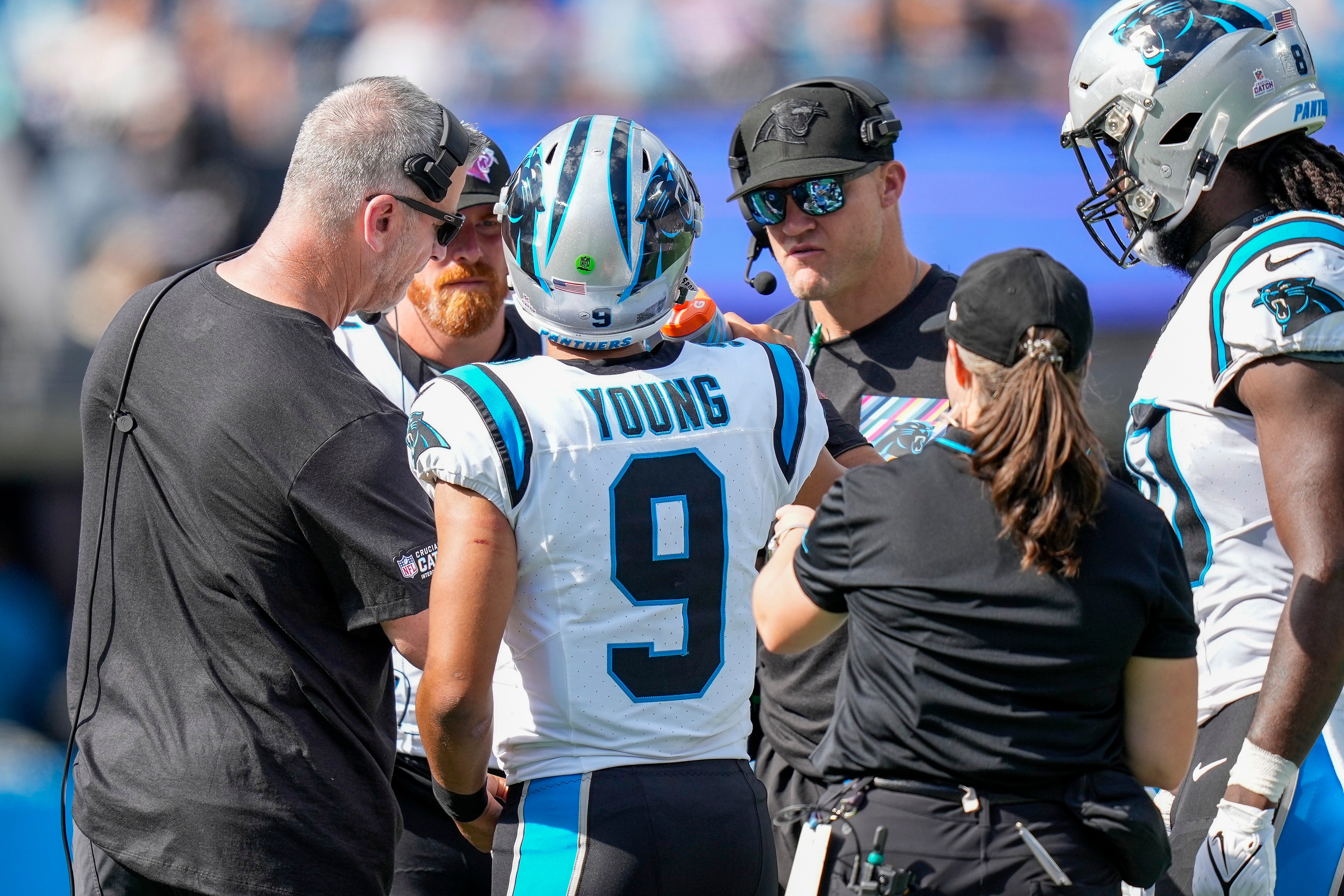 Oct 1, 2023; Charlotte, North Carolina, USA; Carolina Panthers quarterback Bryce Young (9) is surrounded during a time out by head coach Frank Reich, quarterback Andy Dalton (14) and quarterbacks coach Josh McCown during the second half at Bank of America Stadium. Mandatory Credit: Jim Dedmon-USA TODAY Sports.