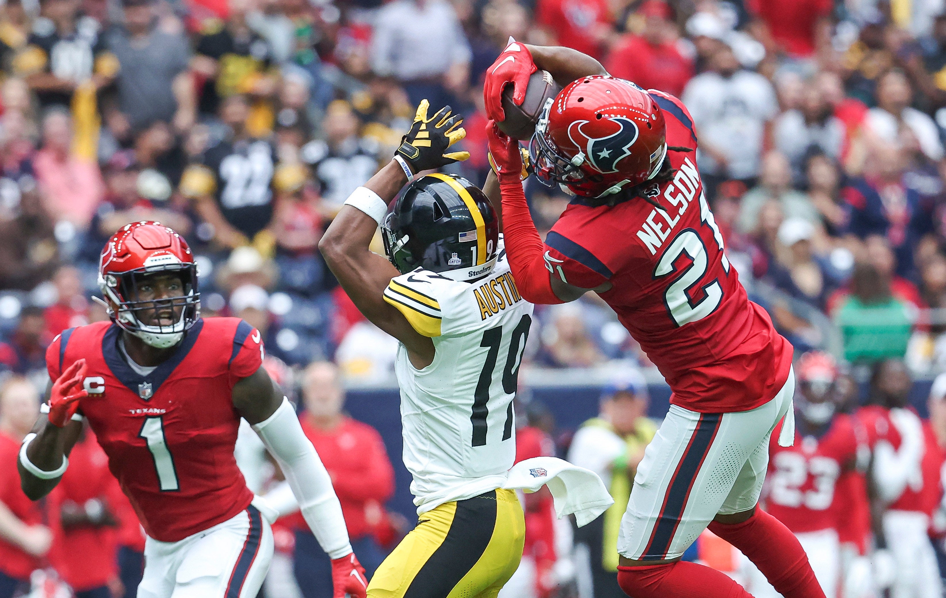 Oct 1, 2023; Houston, Texas, USA; Houston Texans cornerback Steven Nelson (21) intercepts a pass intended for Pittsburgh Steelers wide receiver Calvin Austin III (19) during the first quarter at NRG Stadium. Mandatory Credit: Troy Taormina-USA TODAY Sports  